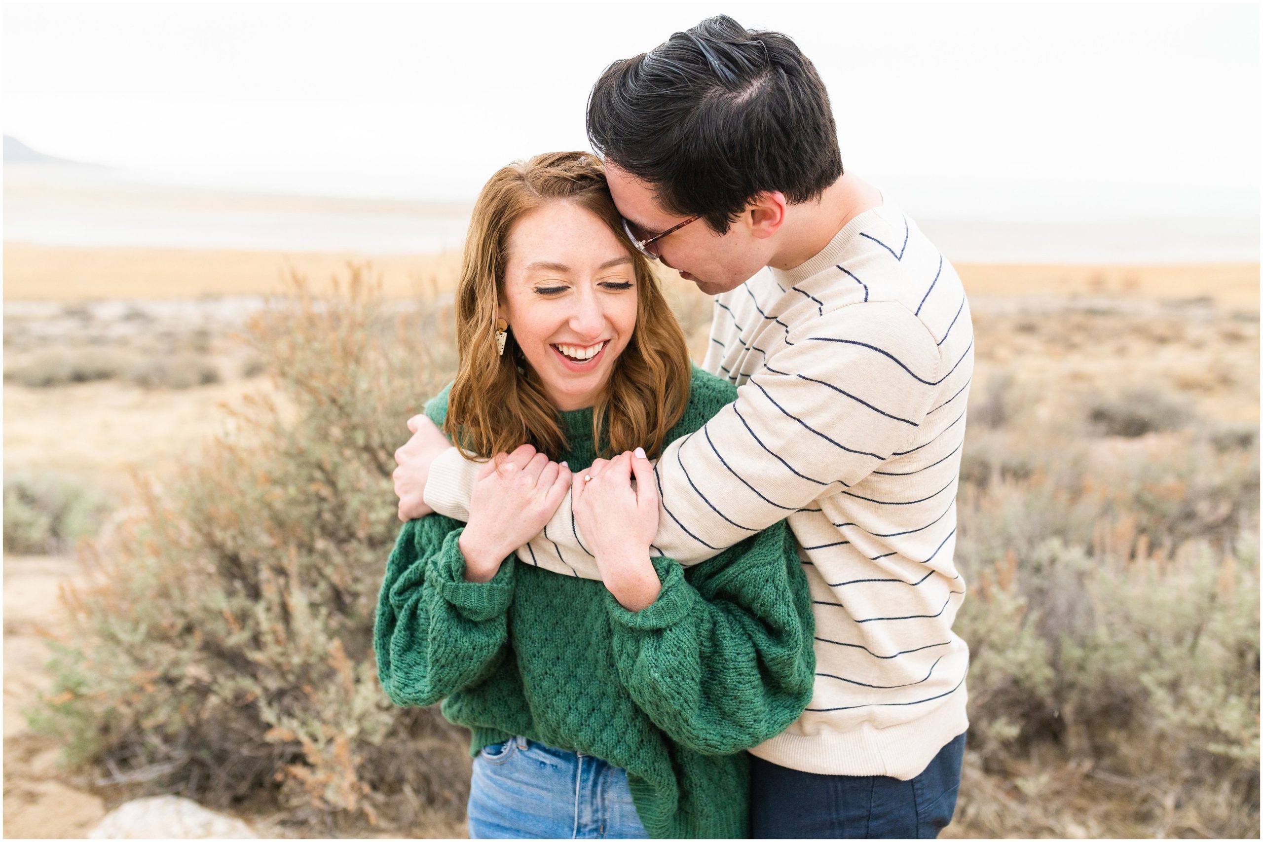 Couple laughing during Antelope Island Stormy Engagement Session | Jessie and Dallin Photography