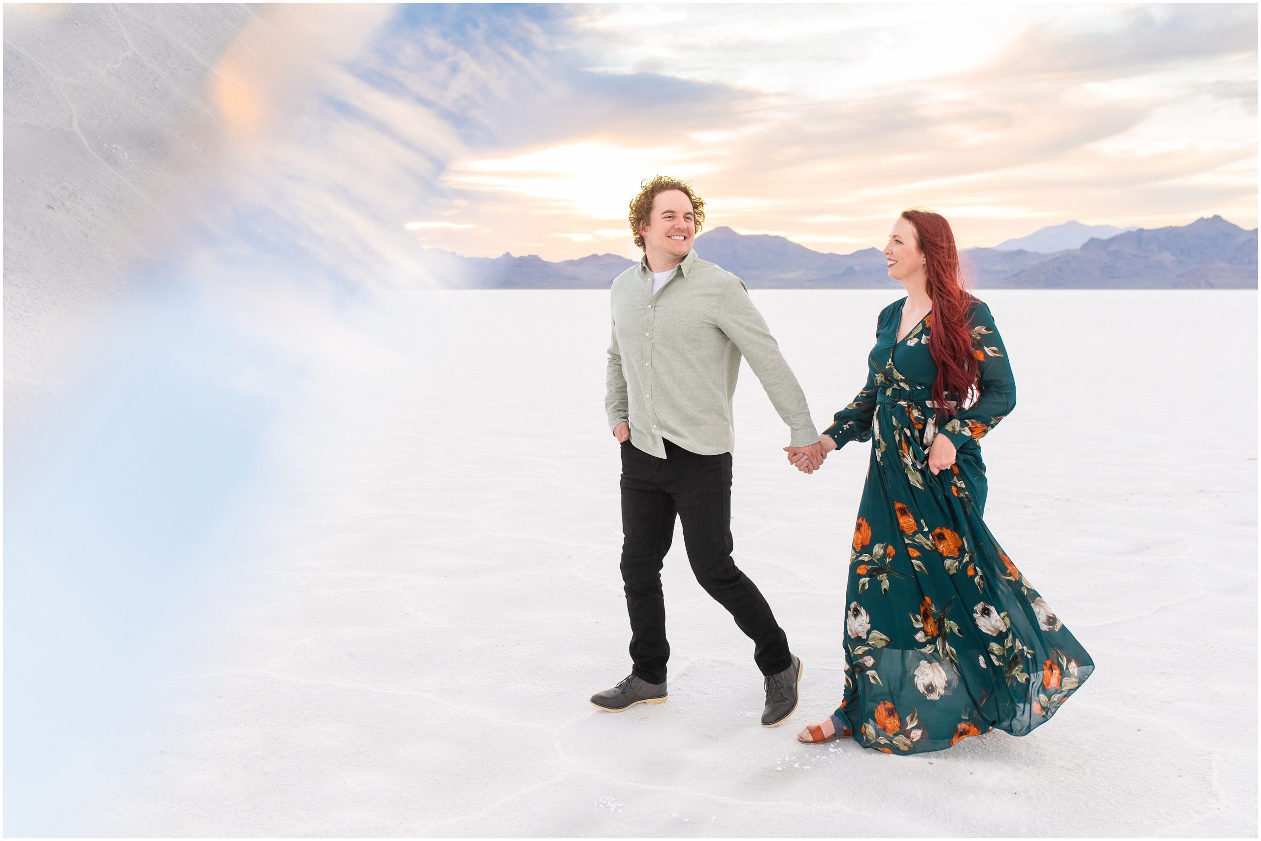 Couple during the most incredible sunset at their Bonneville Salt Flats Sunset Engagement | Jessie and Dallin Photography