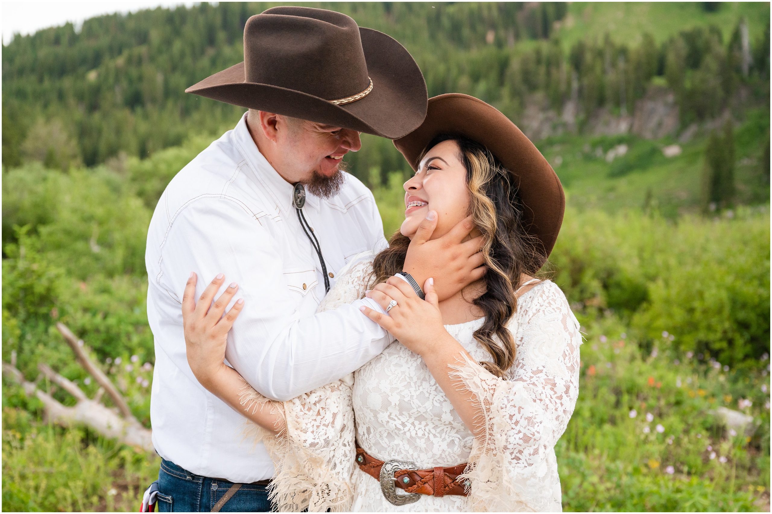 Couple in western outfits and cowboy hats during engagement session | Tony Grove Western Destination Engagement