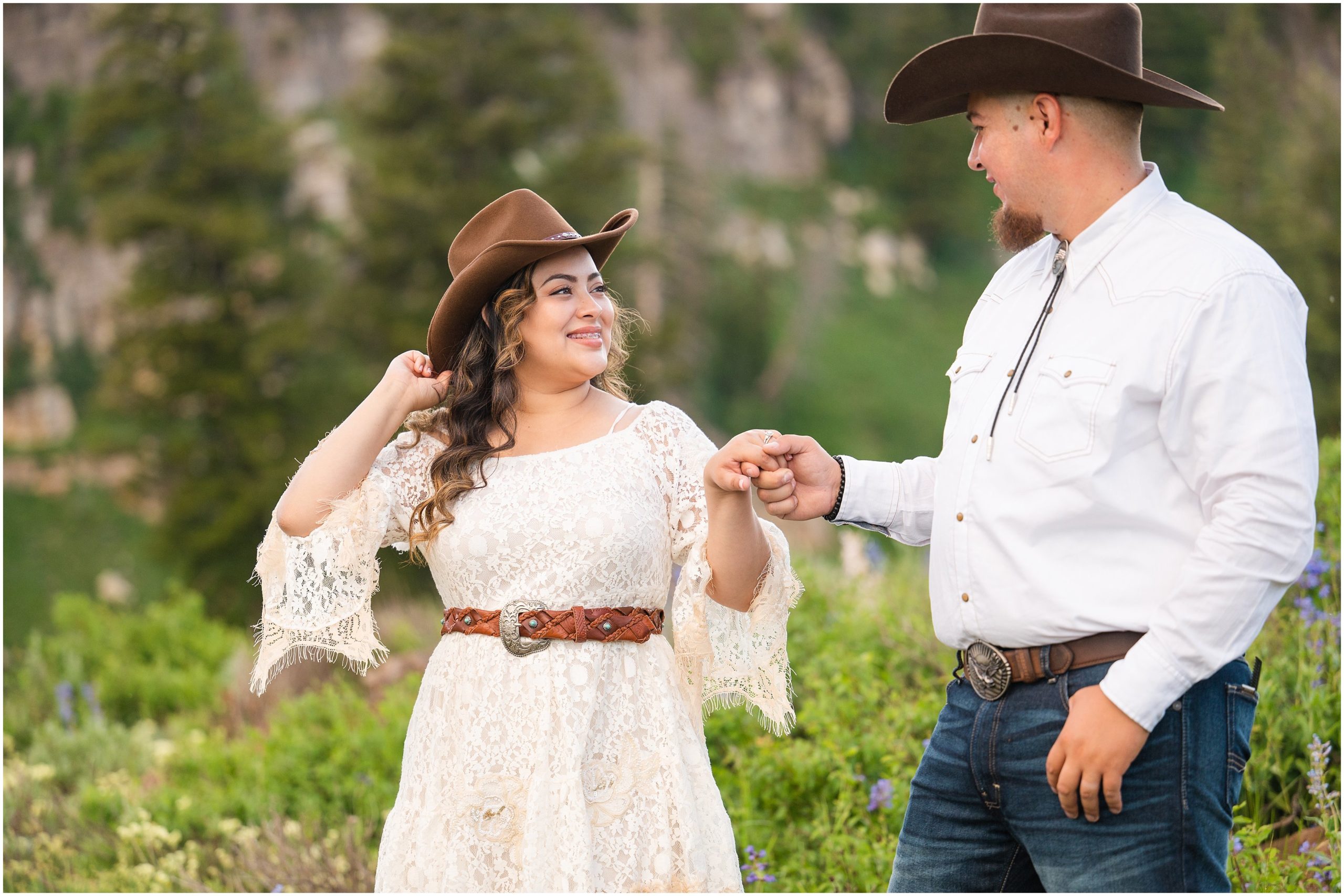 Couple in western outfits and cowboy hats during engagement session | Tony Grove Western Destination Engagement