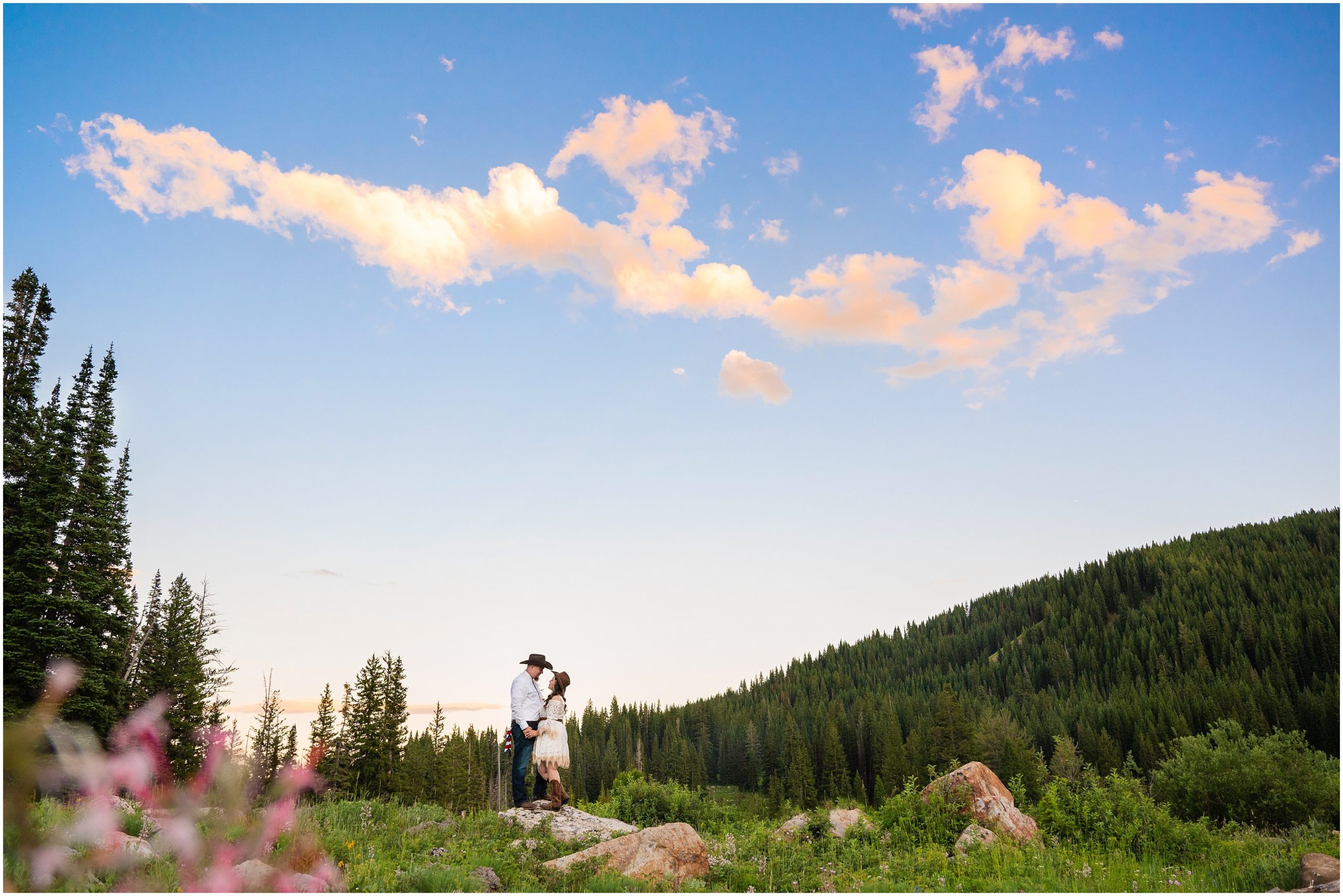 Couple in the mountains at sunset in western outfits during engagement session | Tony Grove Western Destination Engagement