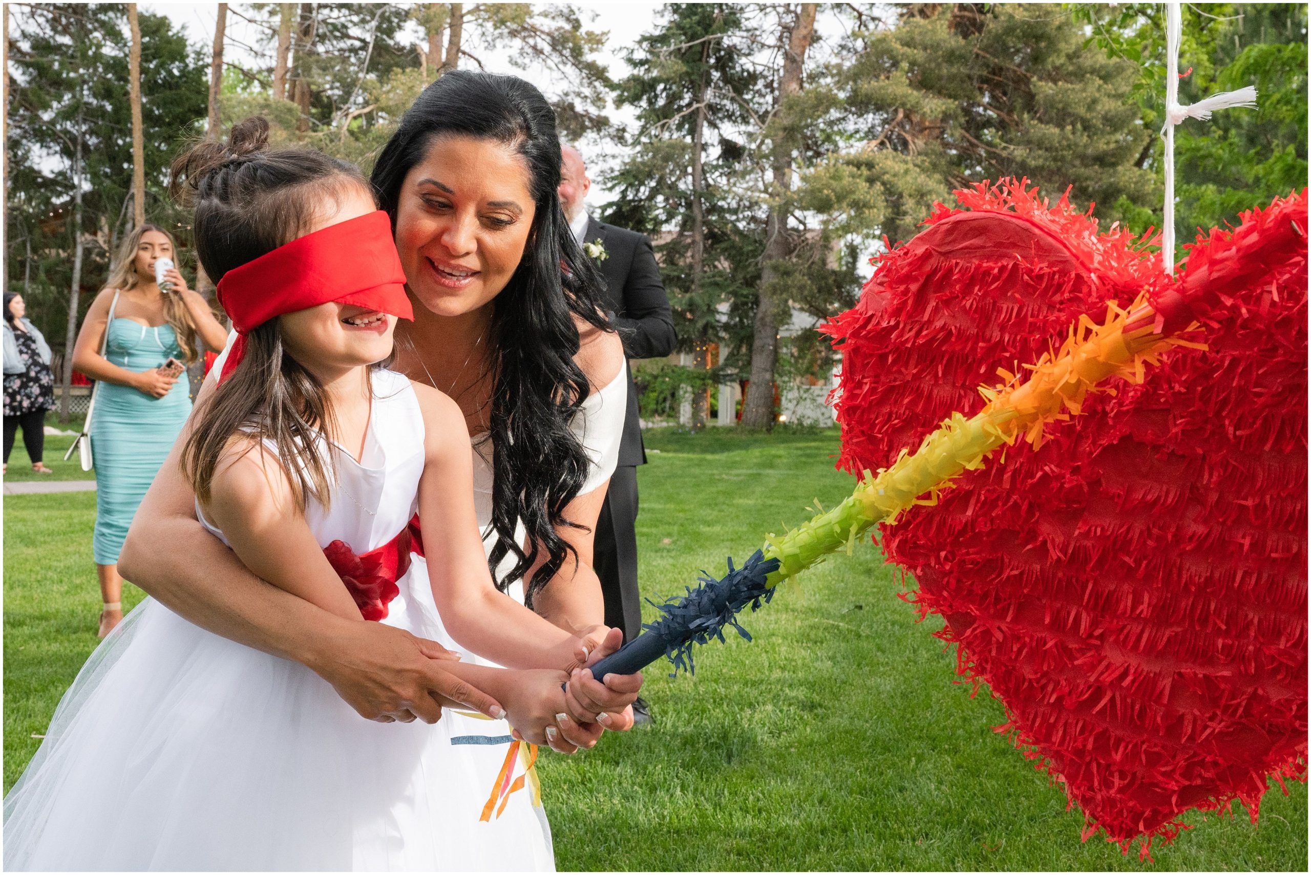 Pinata breaking during wedding | Red and Black Oak Hills Utah Spring Wedding | Jessie and Dallin Photography