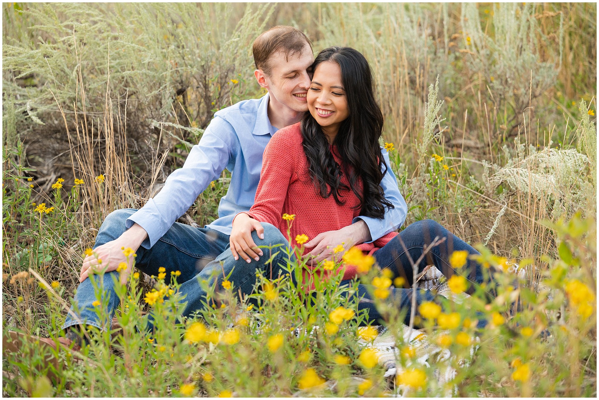 Couple laughing in the mountains with wildflowers | Summer Utah Mountain Engagement | Jessie and Dallin Photography