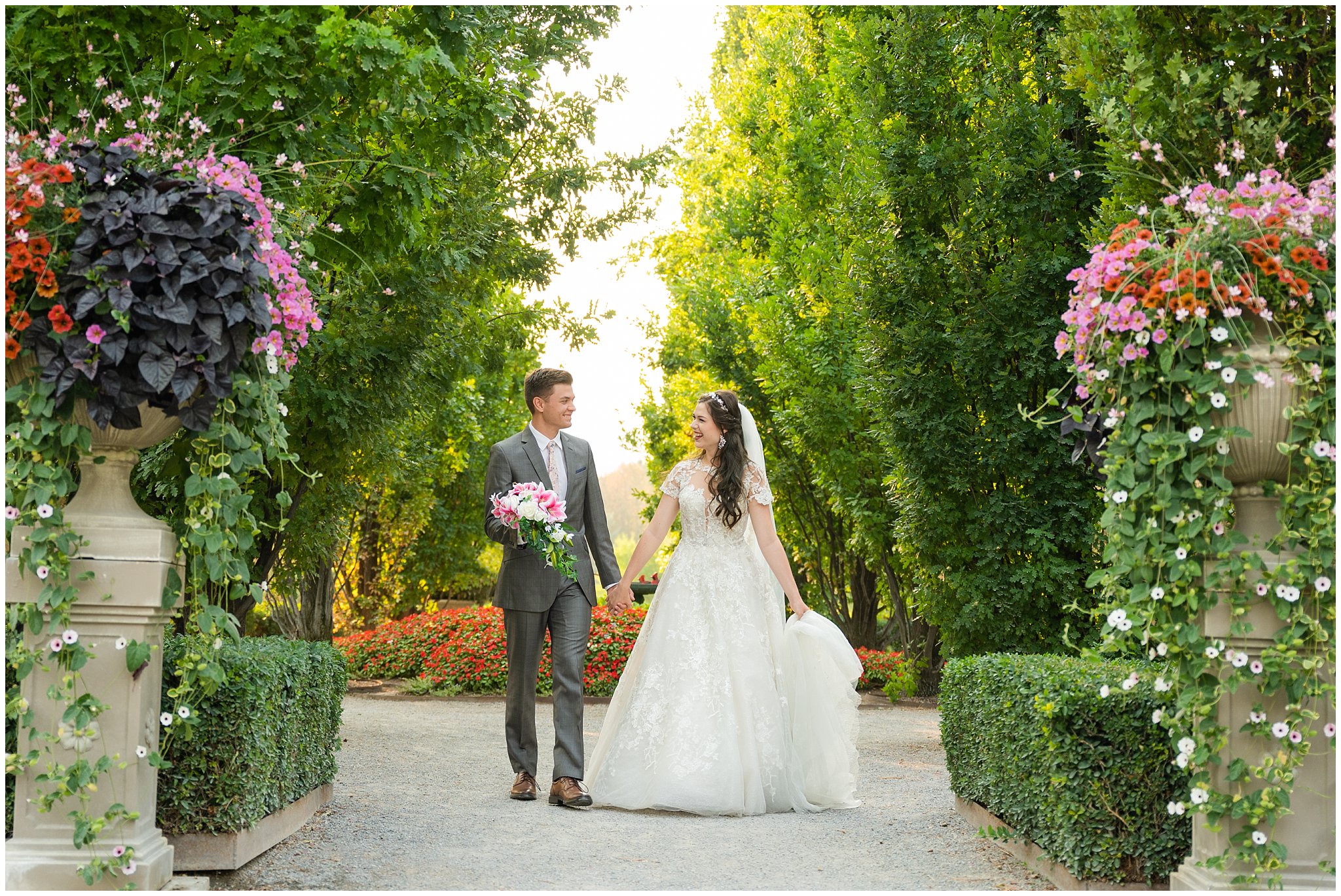 Bride and Groom walking during wedding portraits during the summer surrounded by flowers and gardens | Thanksgiving Point Ashton Garden Formal Session | Jessie and Dallin Photography