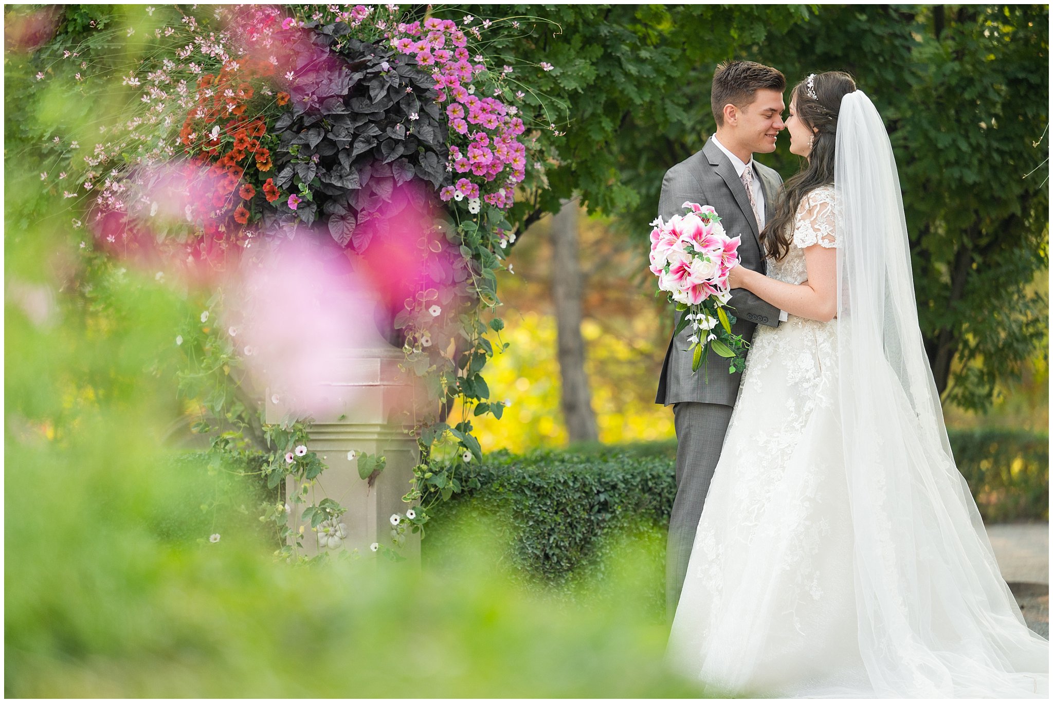 Bride and Groom laughing during wedding portraits during the summer surrounded by flowers and gardens | Thanksgiving Point Ashton Garden Formal Session | Jessie and Dallin Photography
