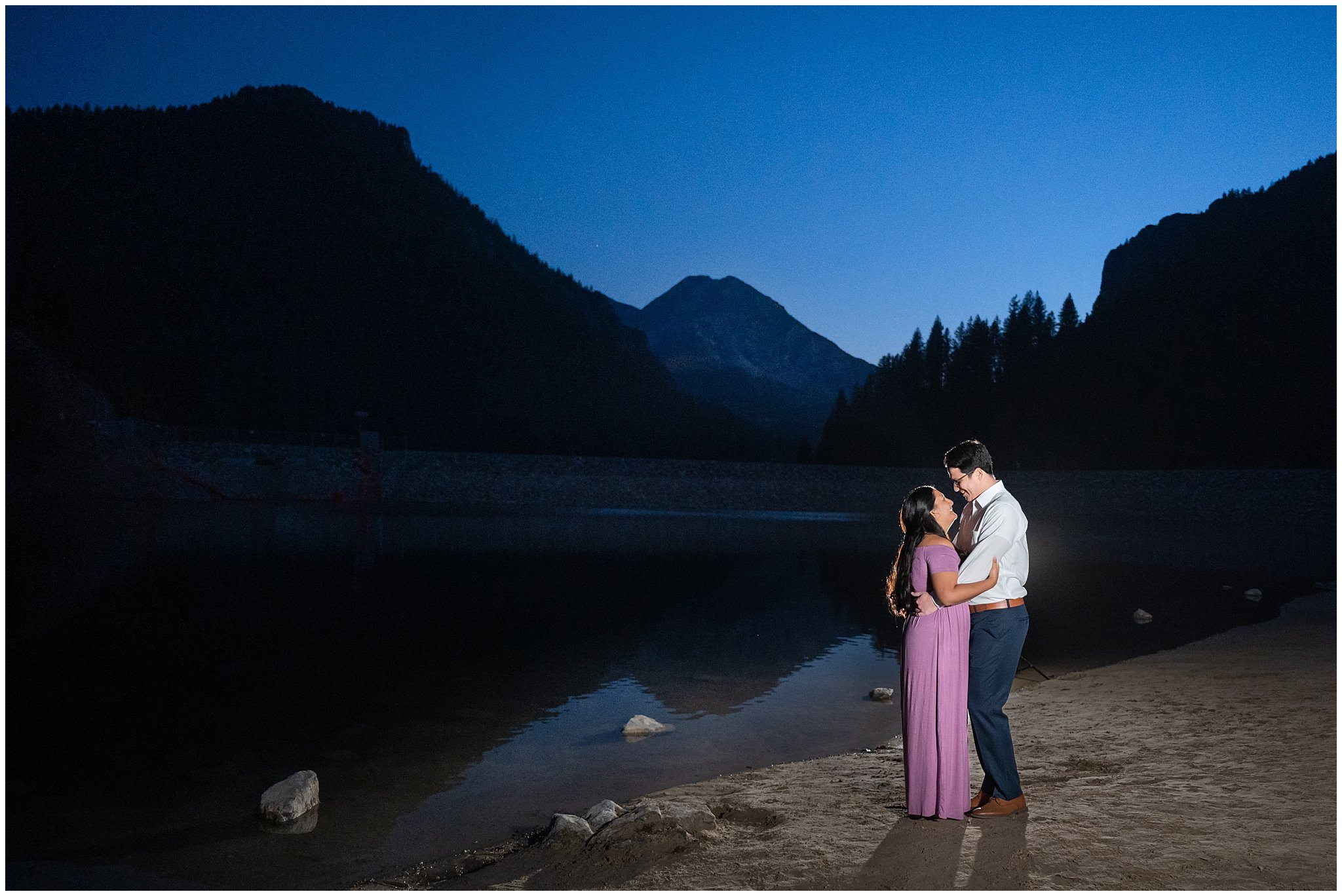 Couple dressed in dress and shirt and tie in the Utah mountains surrounded by water | Tibble Fork Fall Engagement Session | Jessie and Dallin Photography