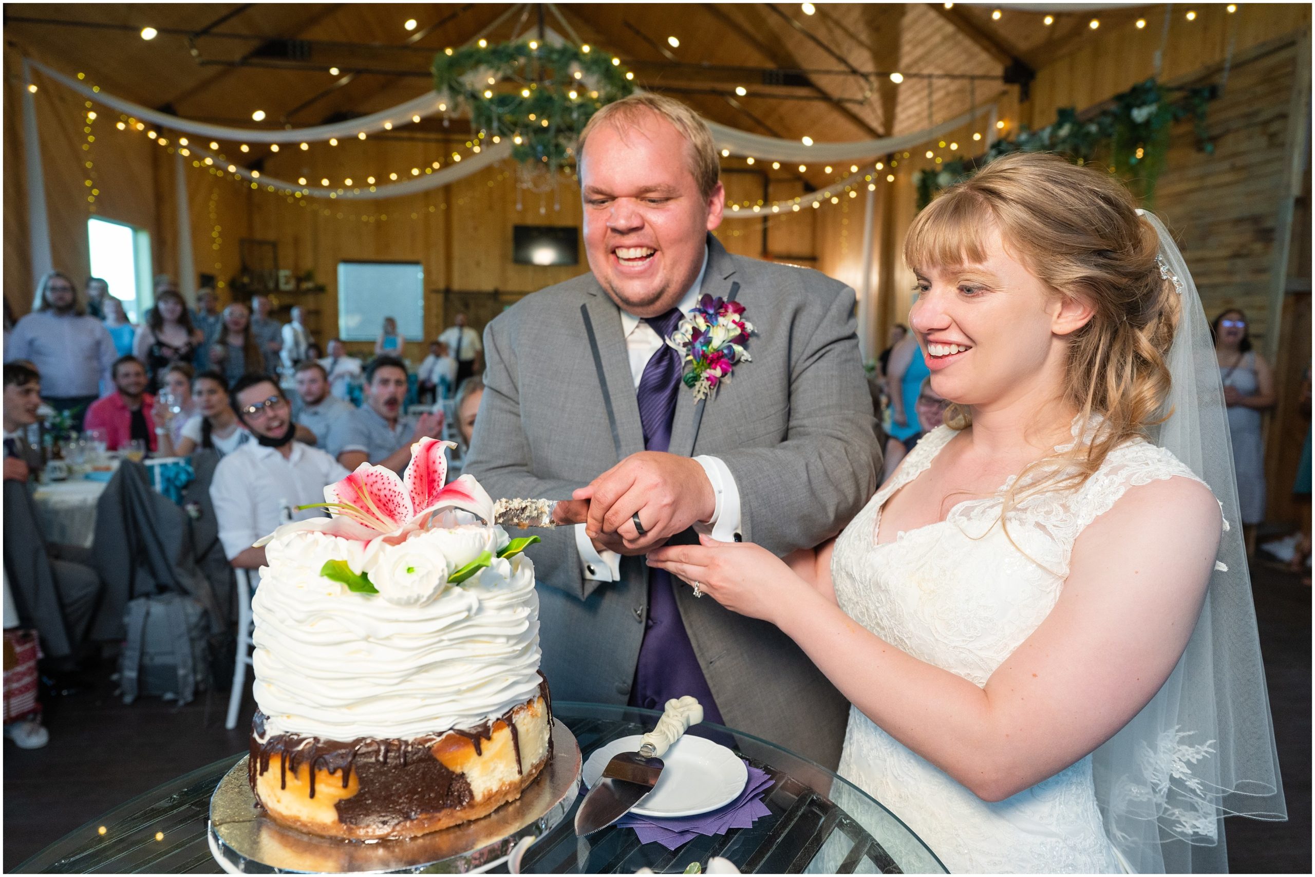Cake cutting in a barn | Orchid Inspired Summer Wedding at Oak Hills Utah | Jessie and Dallin Photography