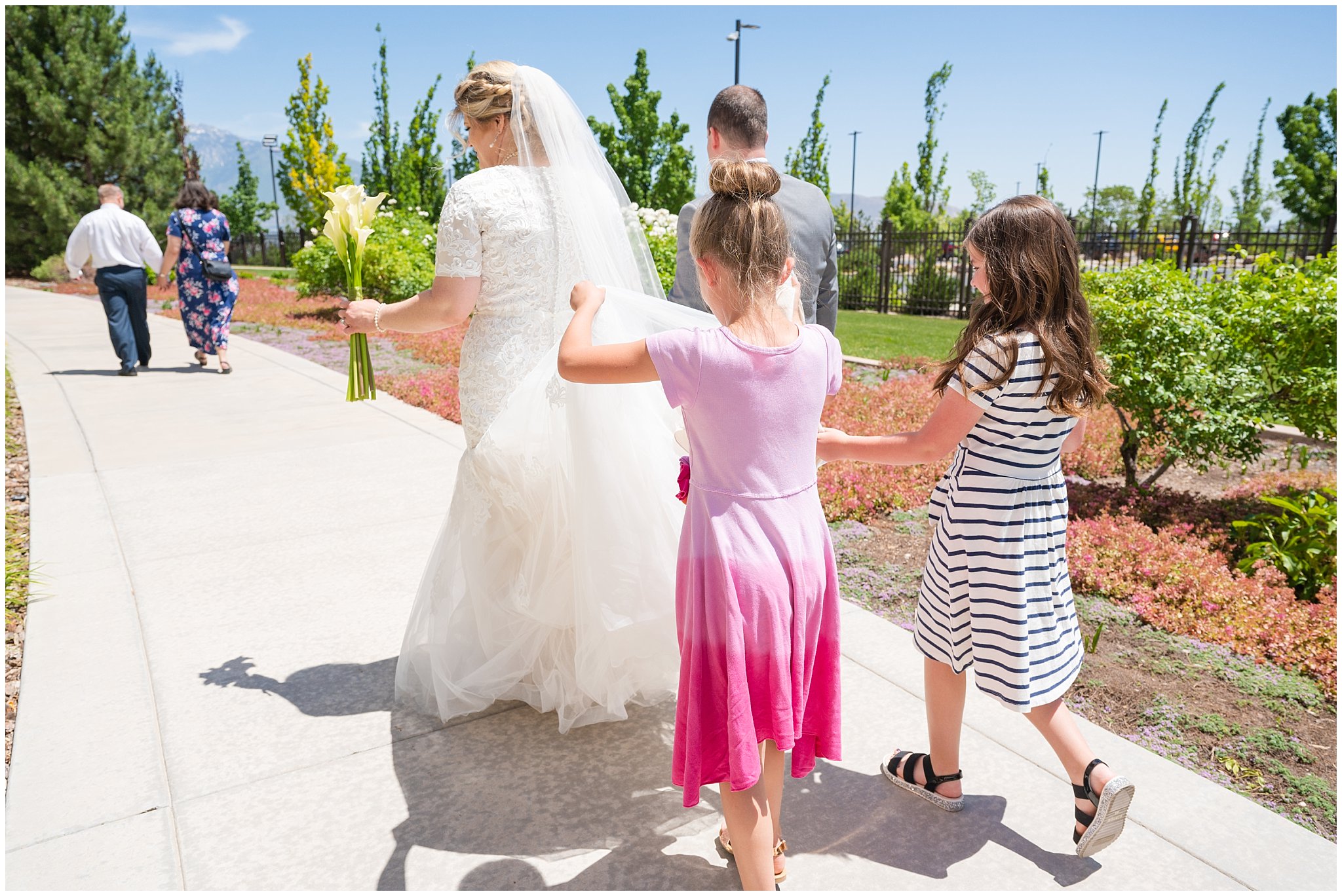 Girls help bride with dress | Oquirrh Mountain Temple and Millennial Falls Wedding | Jessie and Dallin Photography