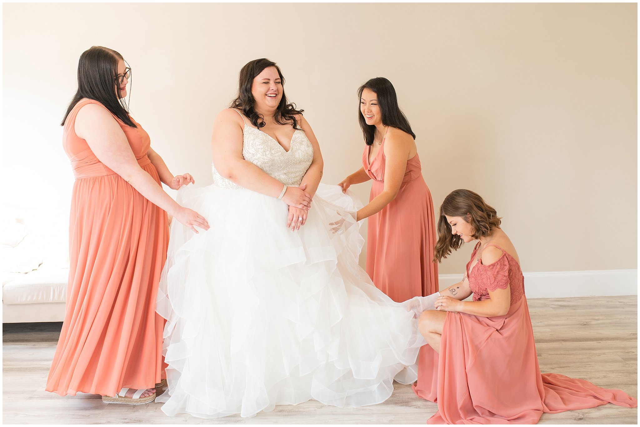 Bride getting ready with bridesmaids in salmon pink dresses | Green and Salmon Pink Utah Wedding | Oak Hills | Jessie and Dallin Photography