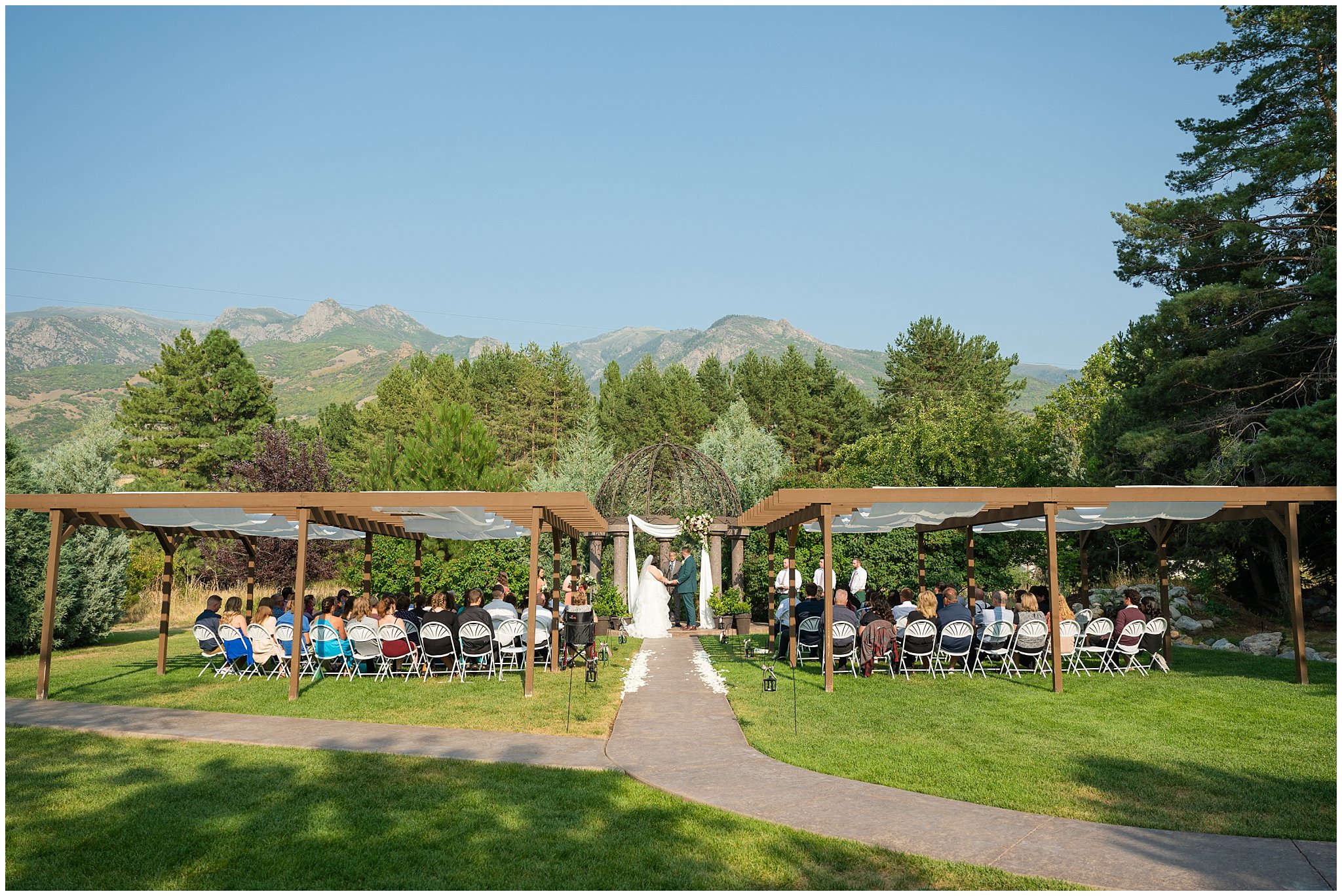 Wedding ceremony with the utah mountains in the background | Green and Salmon Pink Utah Wedding | Oak Hills | Jessie and Dallin Photography