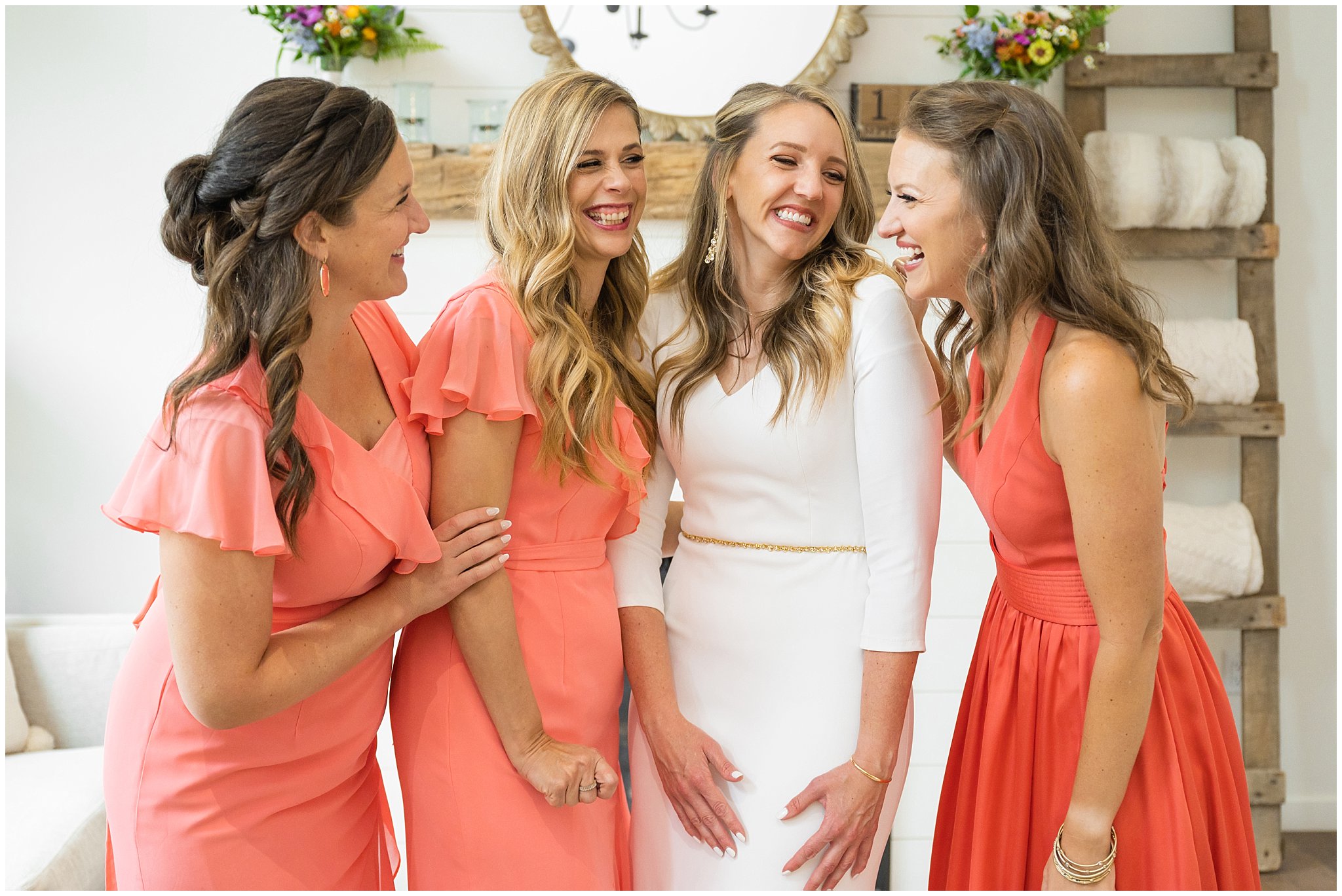 Bride with bridesmaids getting ready inside modern cabin in coral pink dresses | Mountainside Weddings Kalispell Montana Destination Wedding | Jessie and Dallin Photography