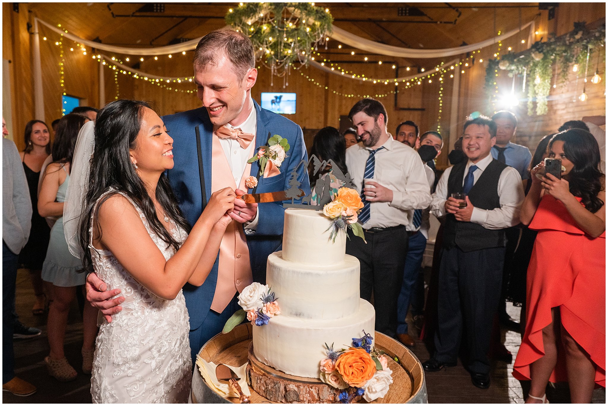 Cake cutting during reception in a barn | Oak Hills Utah Destination Wedding | Jessie and Dallin Photography
