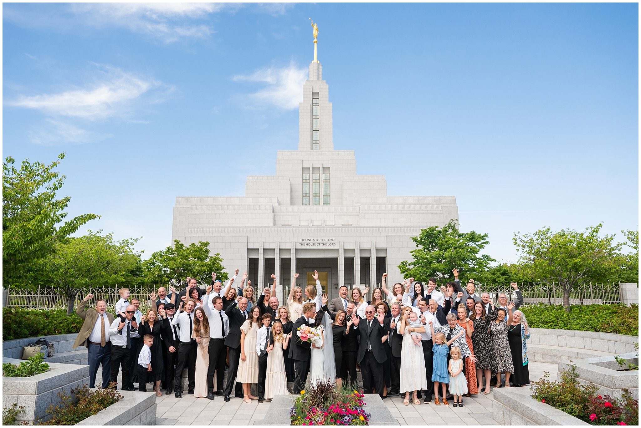 Large family photo cheering in front of the temple | Draper Temple and Wadley Farms Summer Castle Wedding | Jessie and Dallin Photography
