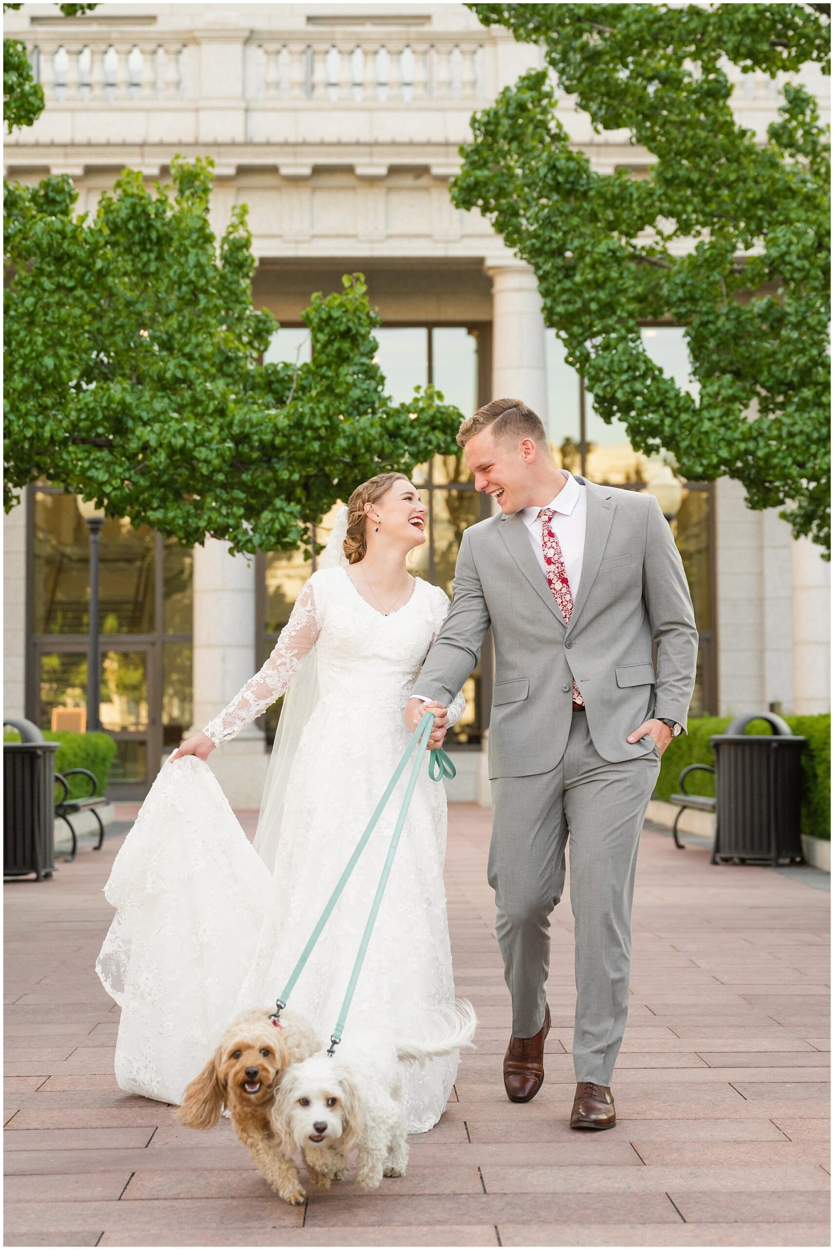 Bride and groom with long cathedral length veil walking their dogs and laughing | Sunset Utah State Capitol Wedding Formal Session | Jessie and Dallin Photography