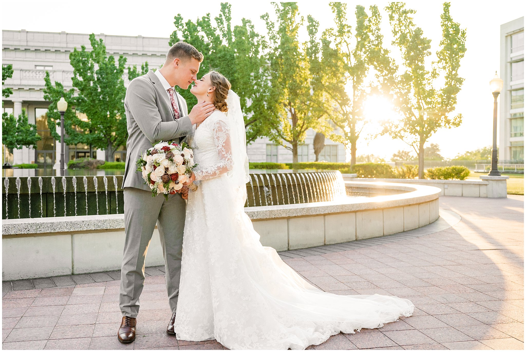 Bride and groom with long cathedral length veil sharing a romantic kiss as the sun sets | Sunset Utah State Capitol Wedding Formal Session | Jessie and Dallin Photography