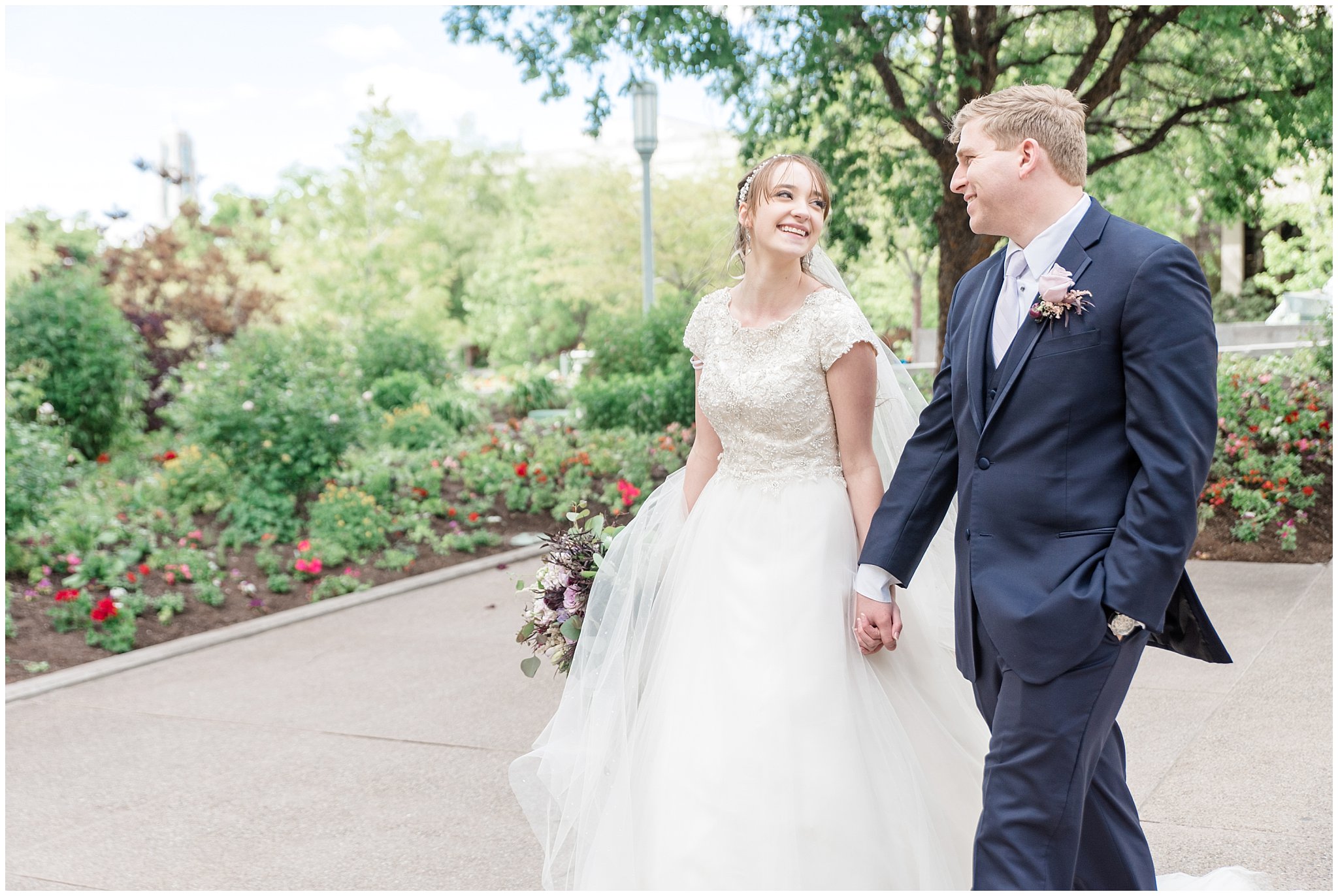 Bride and groom walking the grounds at the Salt Lake Temple | Candid wedding photography