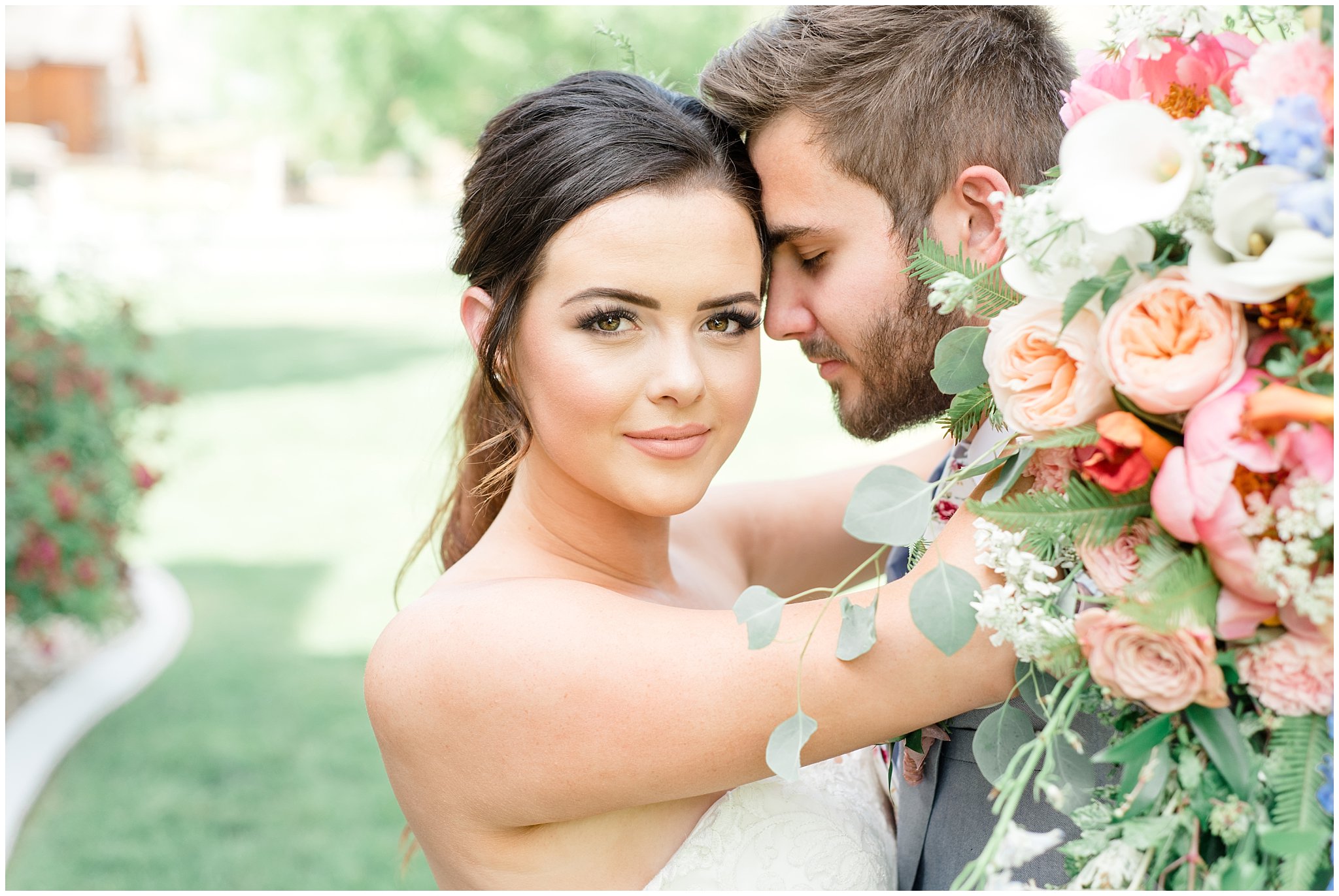 Couple nuzzling close with large green and pink bouquet | This is the Place Heritage Park | Green and Pink Garden Wedding | Jessie and Dallin Photography