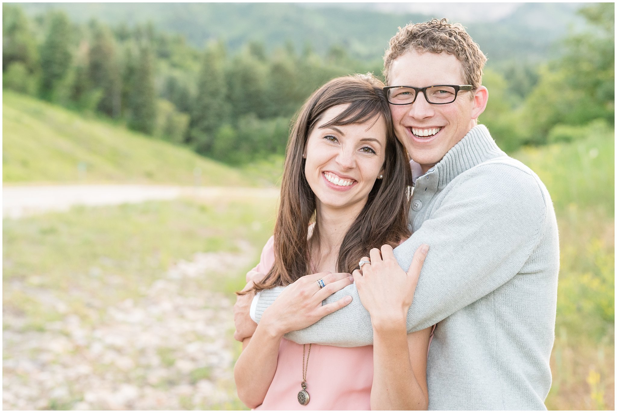 Joyful couple smiling pictures with mountains behind them | Utah couples photography at Snowbasin