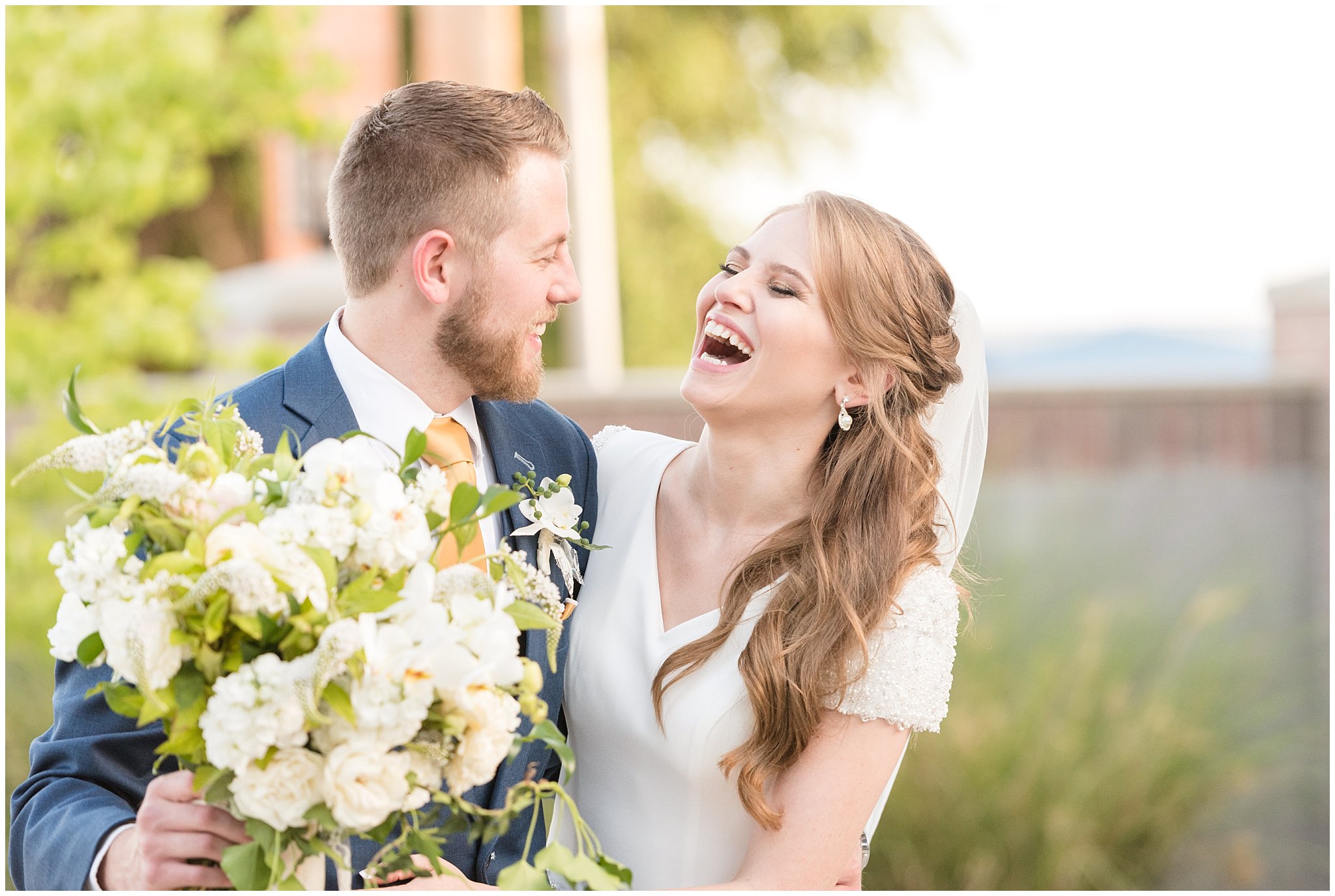 Bride and groom walking and laughing | gold, navy and white wedding | Talia Event Center | Utah Wedding Photography | Jessie and Dallin Photography