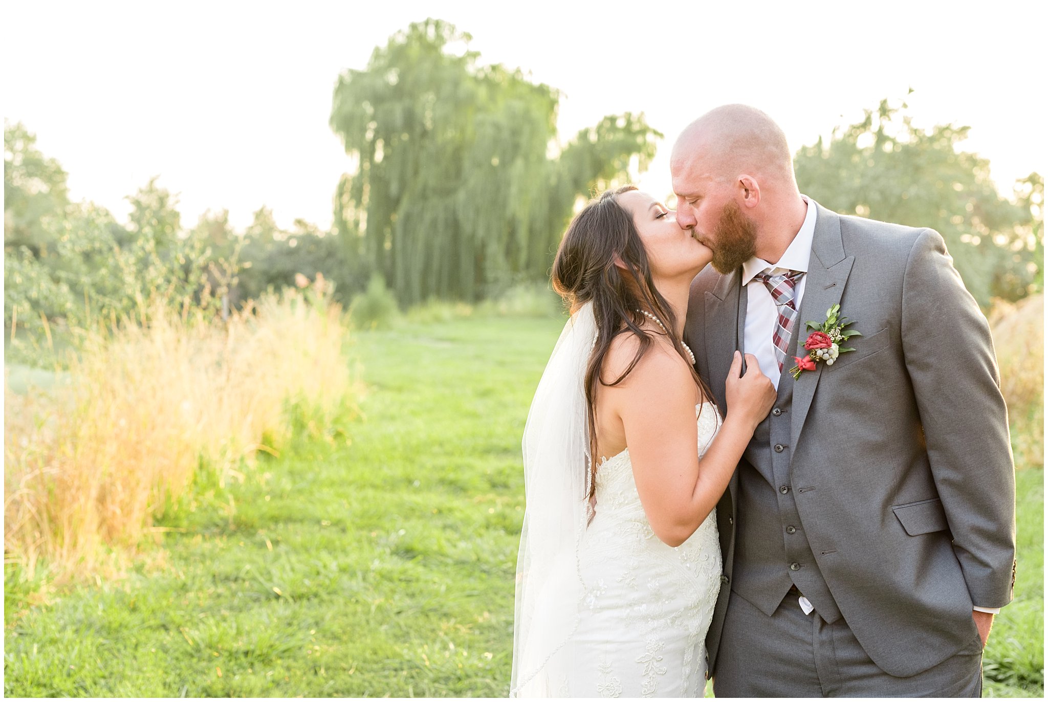 Bride and groom kiss during sunset portraits | Red and Grey wedding | Davis County Outdoor Wedding | Jessie and Dallin Photography