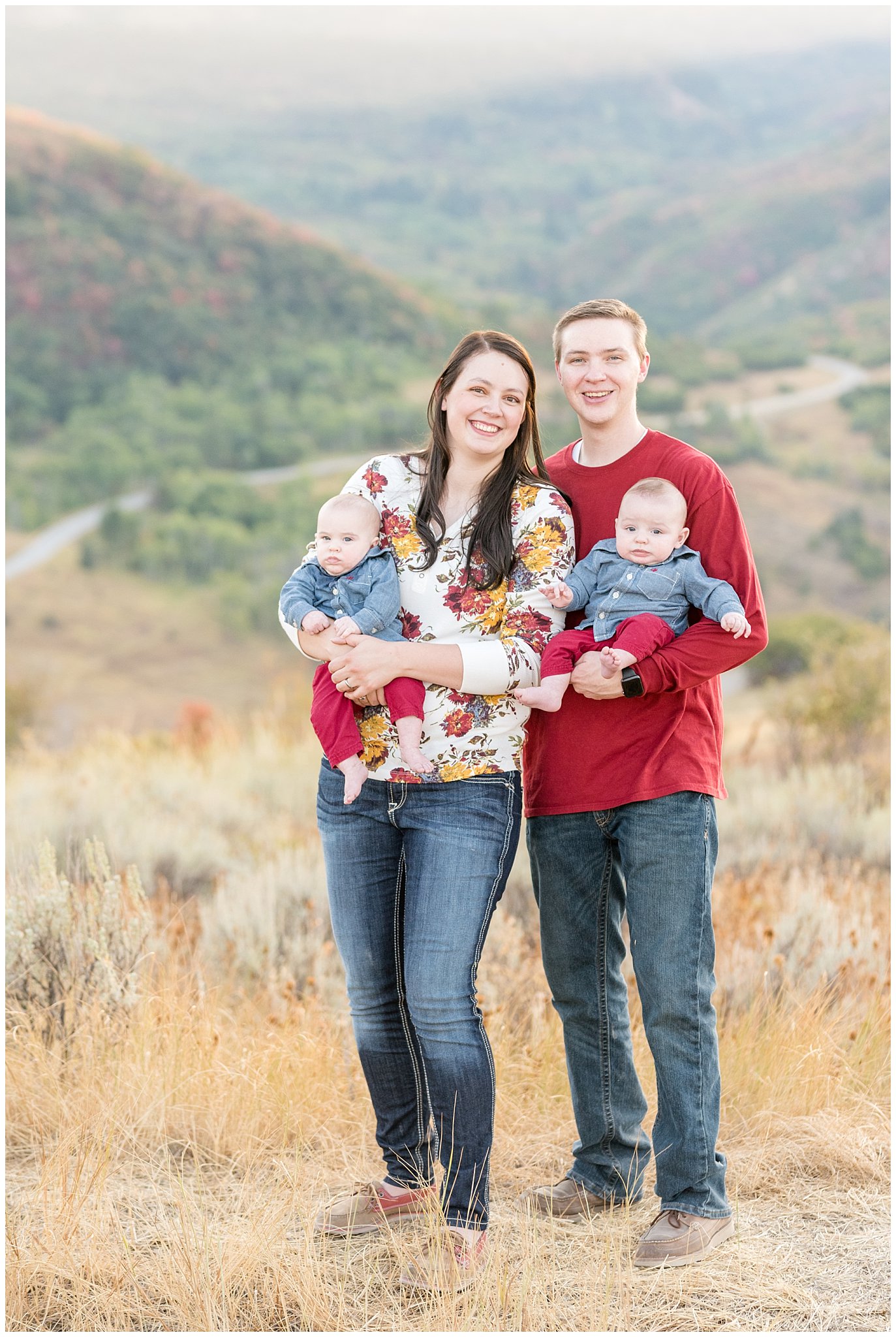 Family picture smiling at the camera with mountains in the background | Fall Family Pictures at Snowbasin | Jessie and Dallin Photography