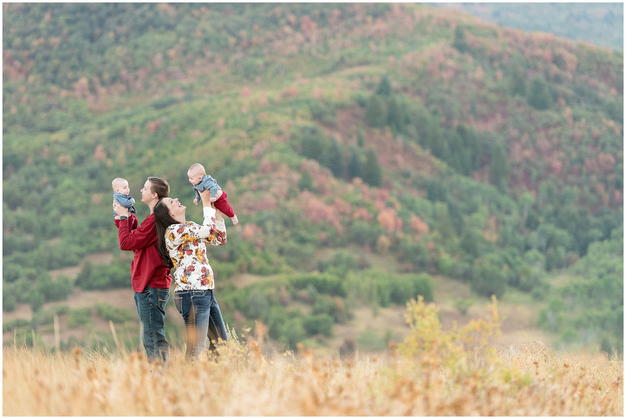 Couple lifting twin infants in the air in the mountains | Fall Family Pictures at Snowbasin | Jessie and Dallin Photography