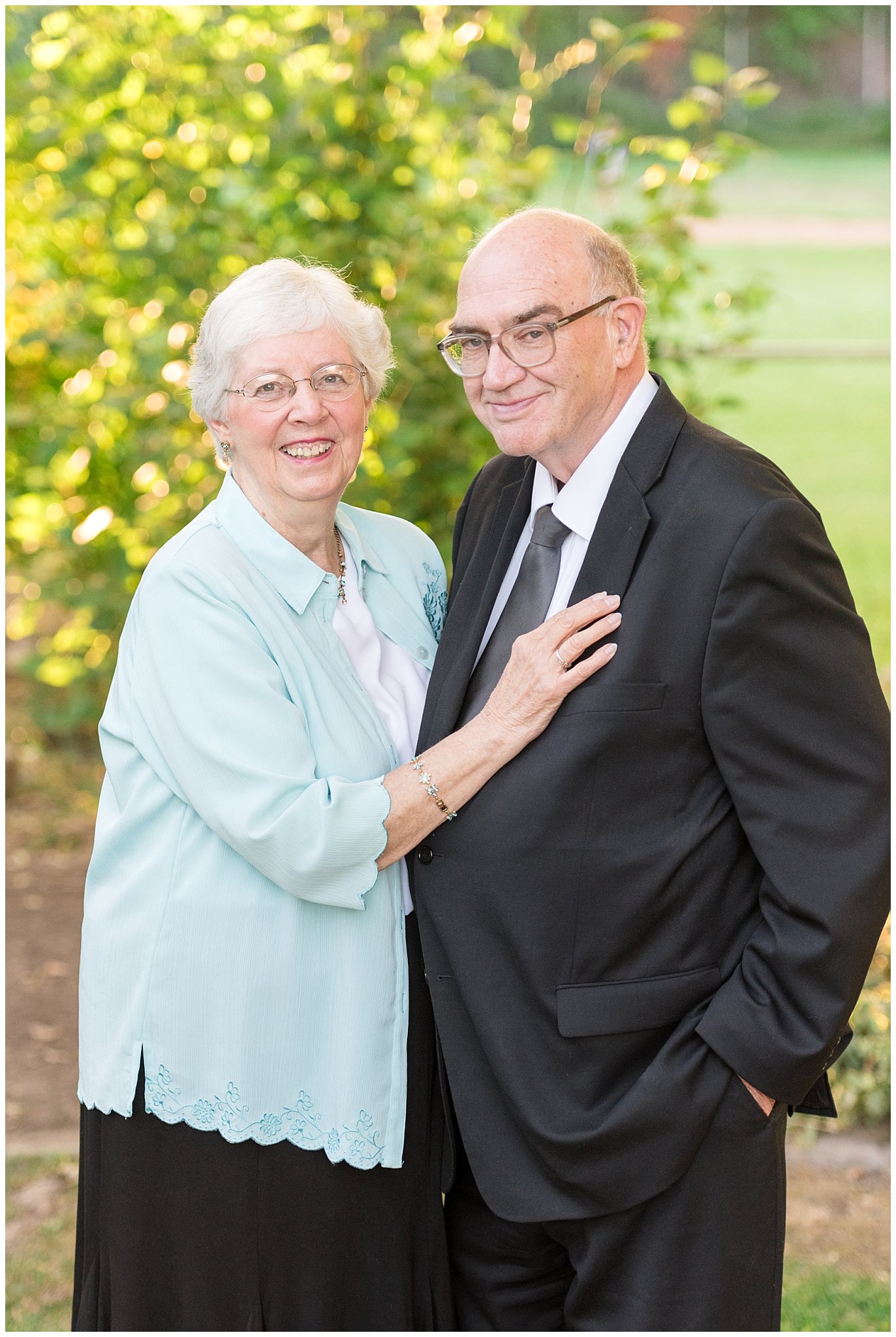 Older couple smiling at the camera surrounded by trees | Layton Commons Park | Layton Couples Photographer | Jessie and Dallin