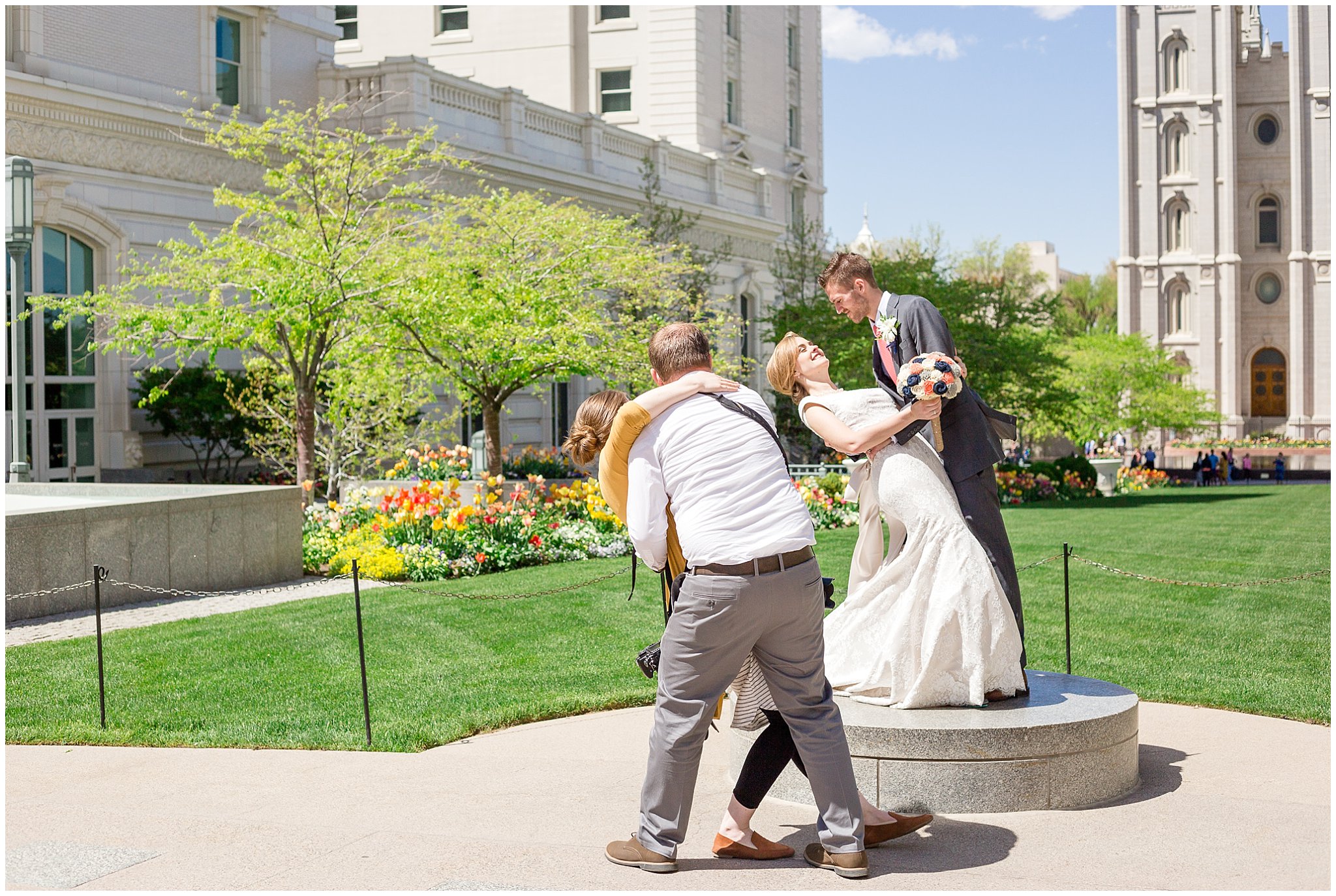 Photographers showing a bride and groom how to pose at the Salt Lake Temple | Utah Wedding Photographer | Jessie and Dallin Photography