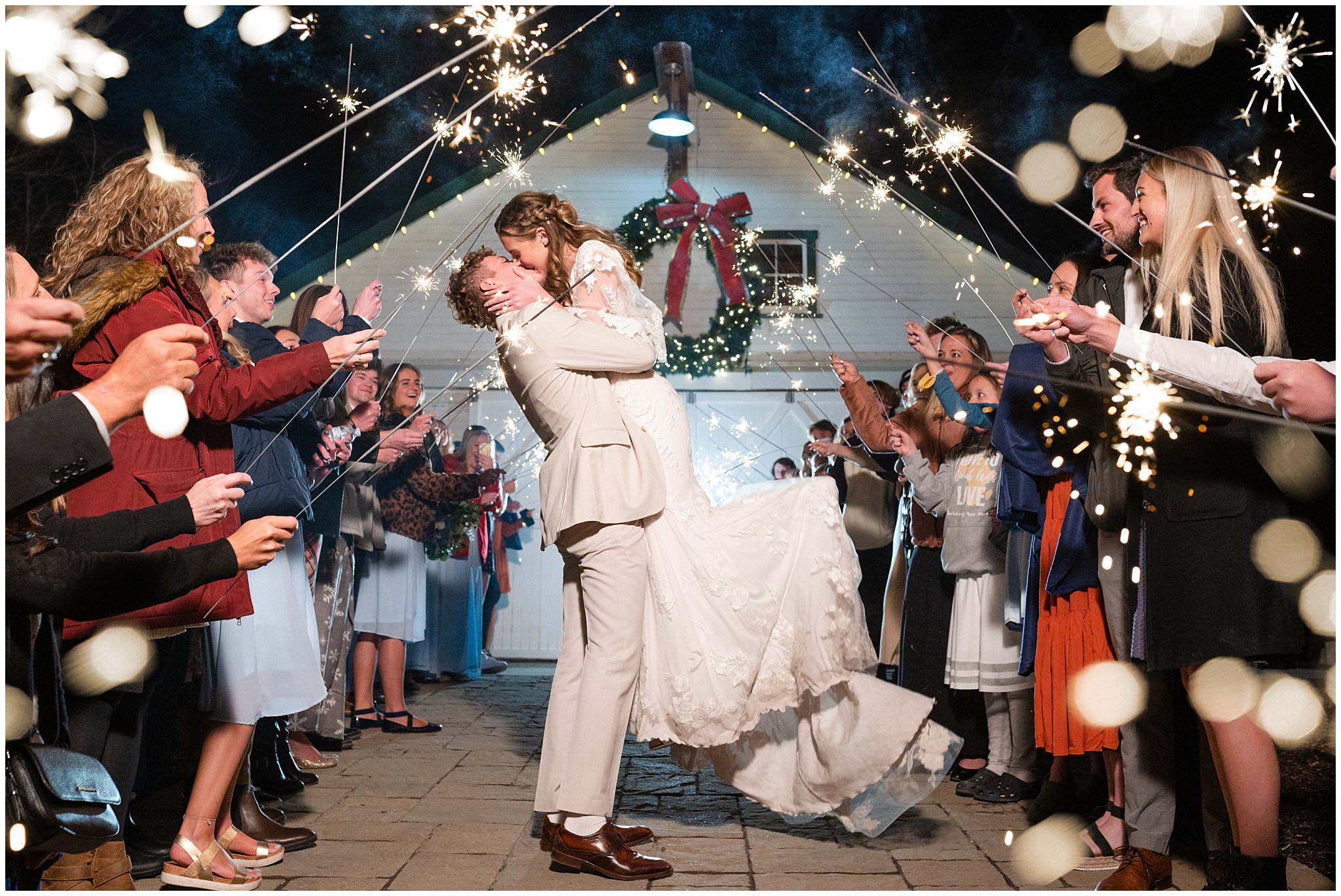 Sparkler exit from white barn at Christmas | Jessie and Dallin Photography
