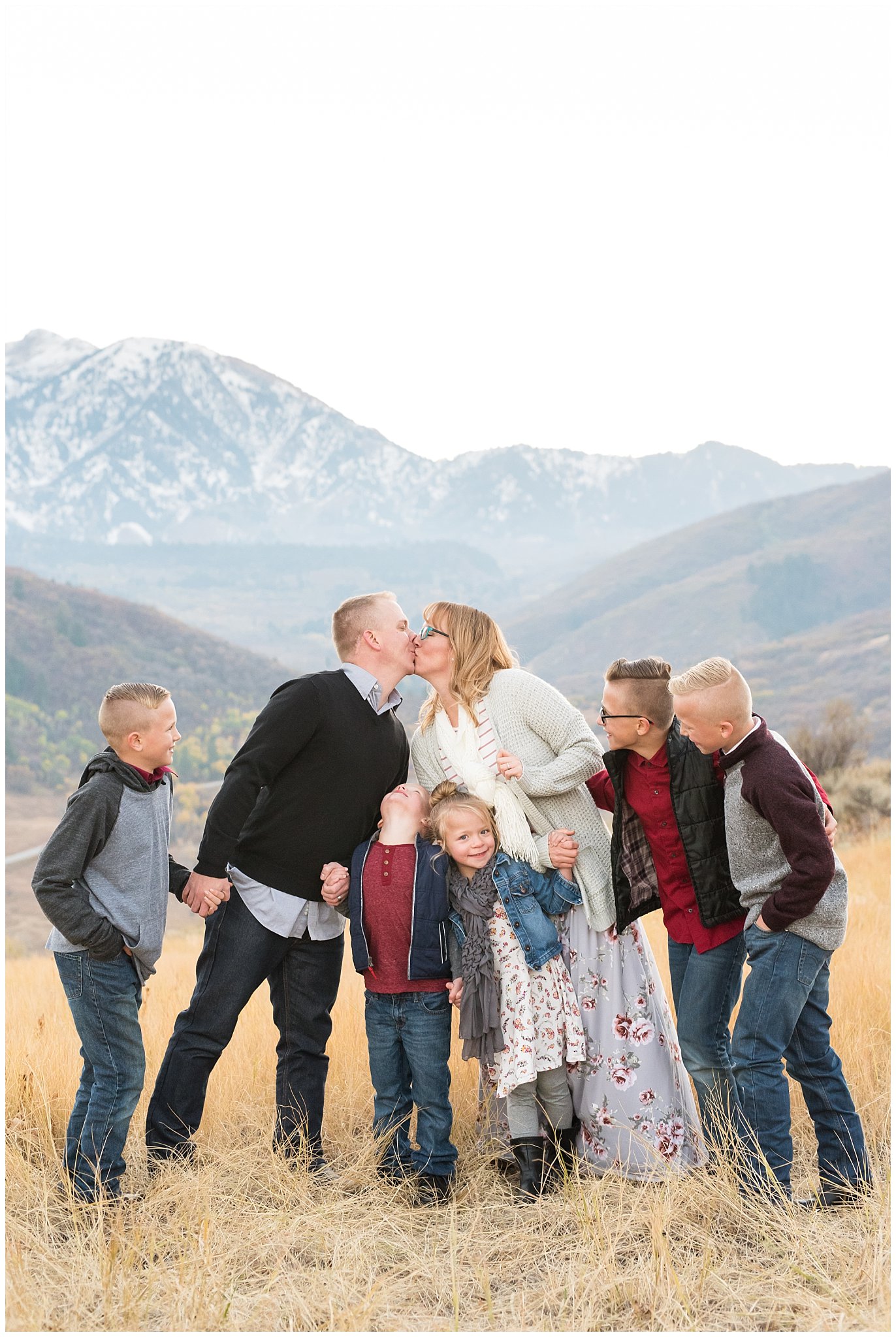 Parents kiss while 5 kids look and laugh | Fall Family Pictures in the Mountains | Snowbasin, Utah | Jessie and Dallin Photography