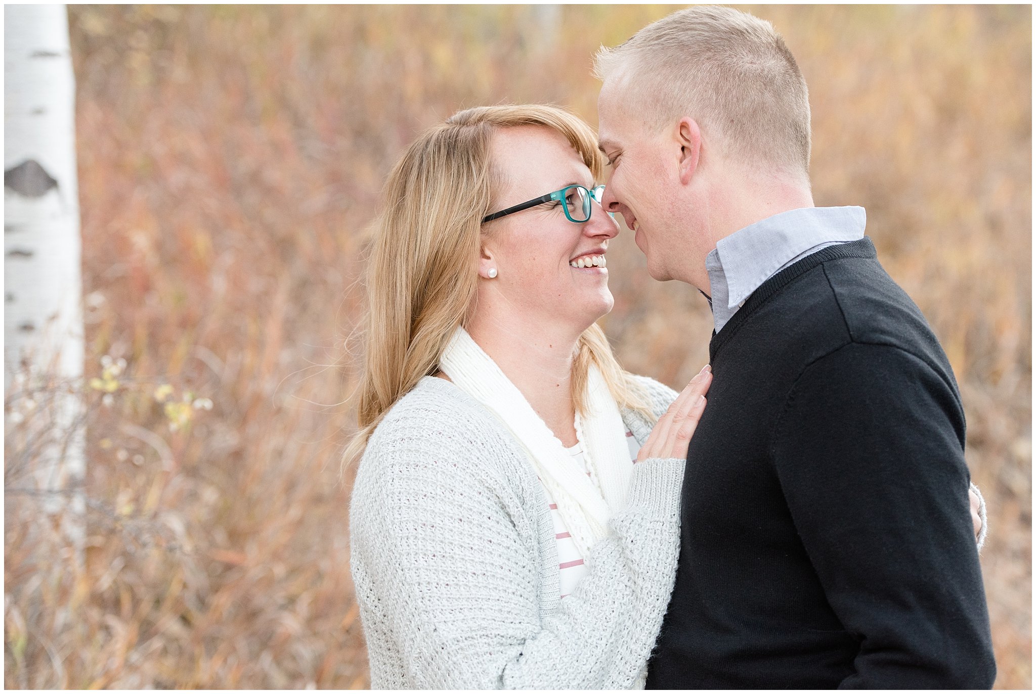 Couple nuzzling close in the cold fall weather | Fall Family Pictures in the Mountains | Snowbasin, Utah | Jessie and Dallin Photography
