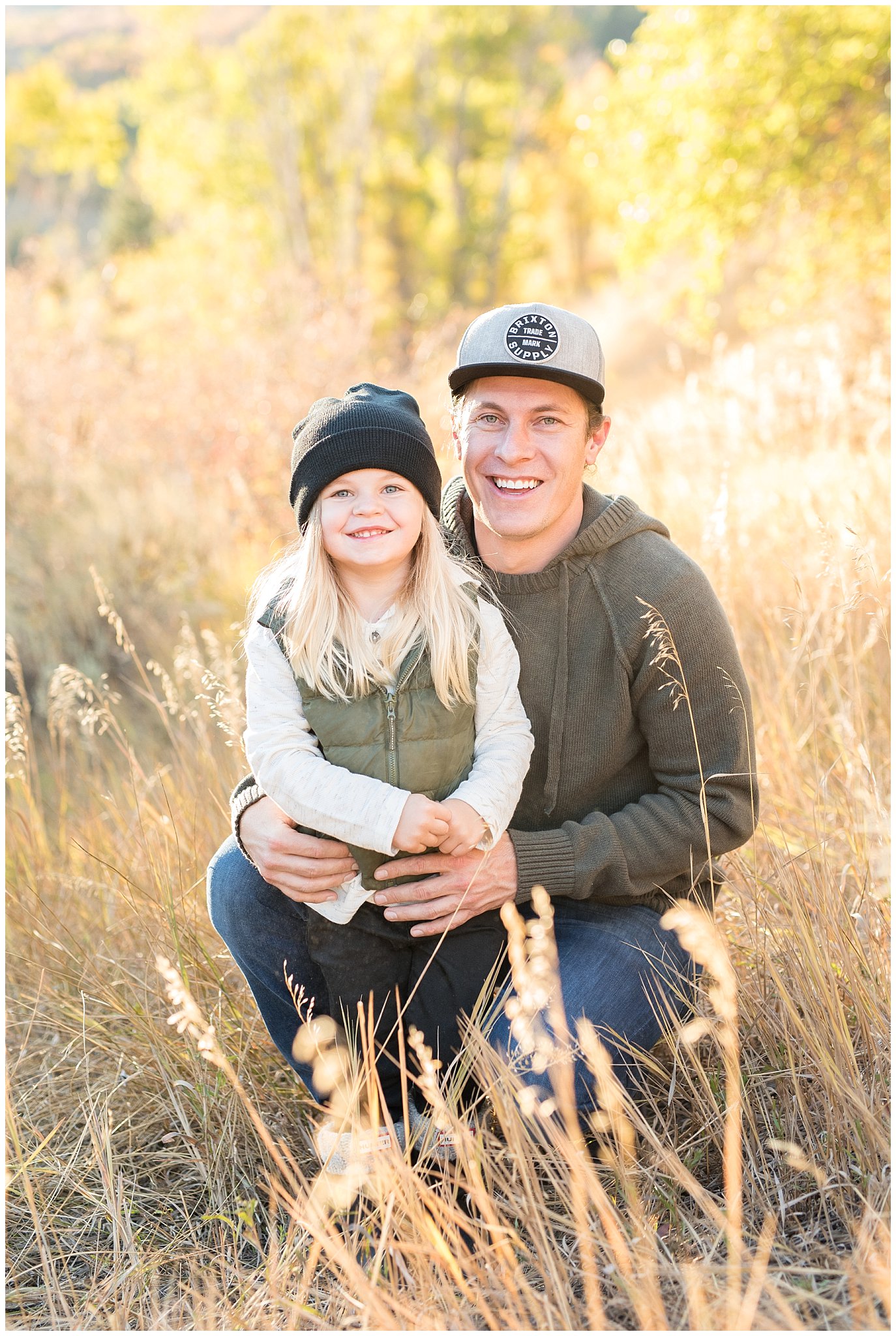 Father and son smiling at the camera at snowbasin in the fall | Fall Family Pictures in the Mountains | Snowbasin, Utah | Jessie and Dallin