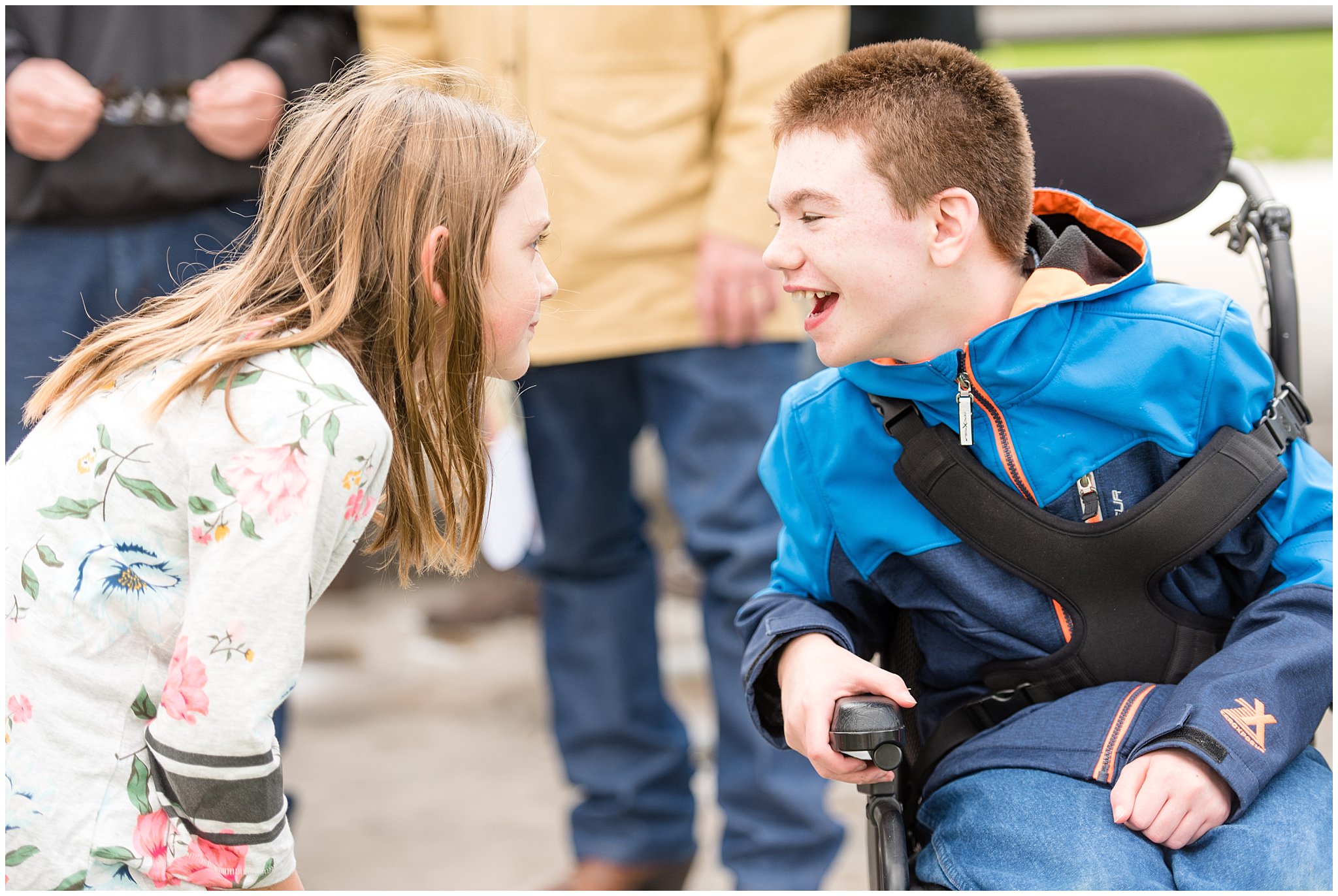 Boy in wheel chair laughing and friend | Tremonton Family Pictures and Make a Wish Event | Jessie and Dallin Photography