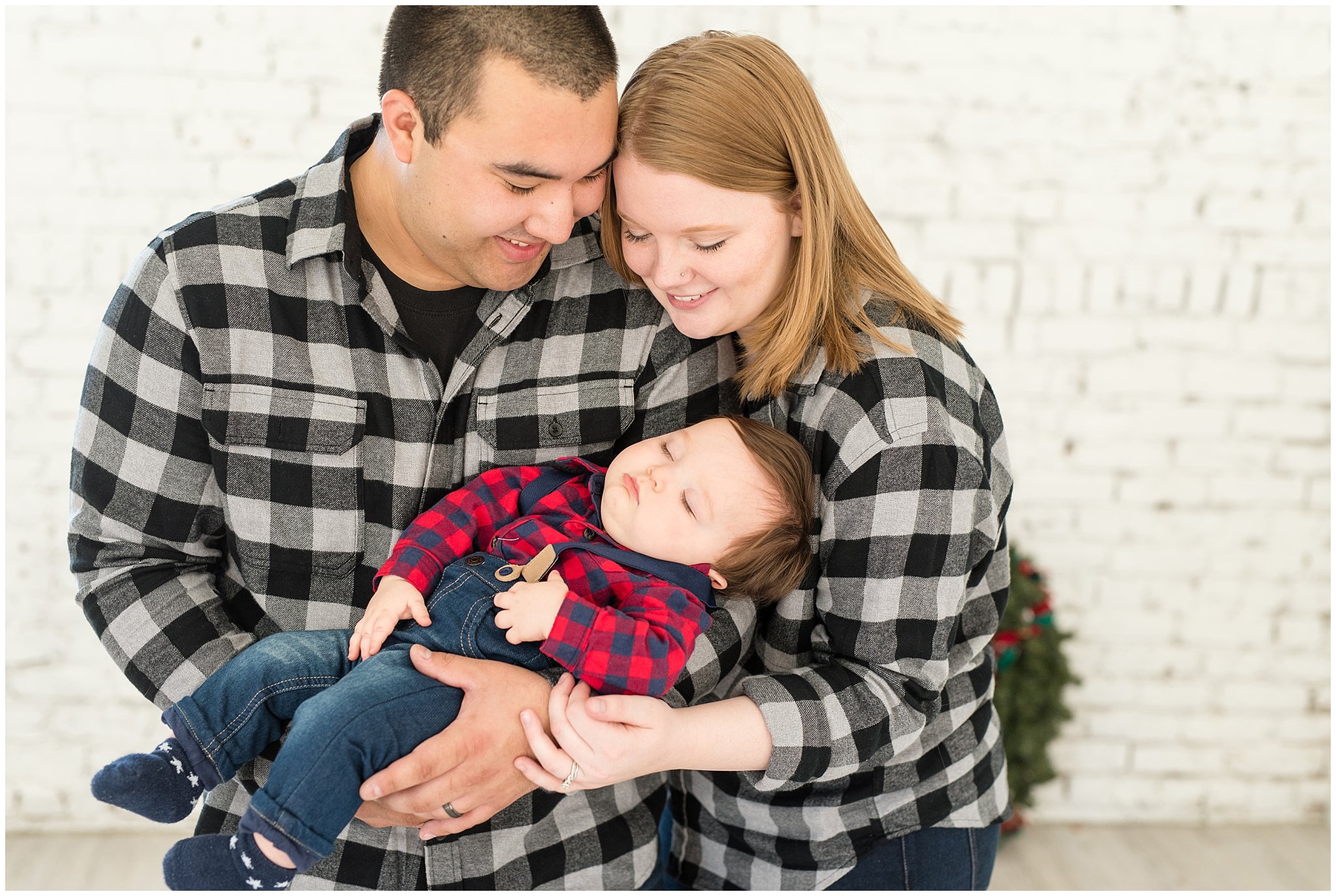Parents rocking sleeping baby | Family Christmas session at the 5th floor | Utah Photographers | Jessie and Dallin Photography