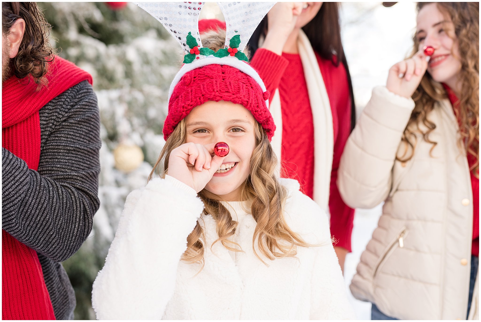 Girl with rudolph nose laughing in front of family | Utah Family Christmas Photoshoot | Oak Hills Reception and Event | Jessie and Dallin Photography