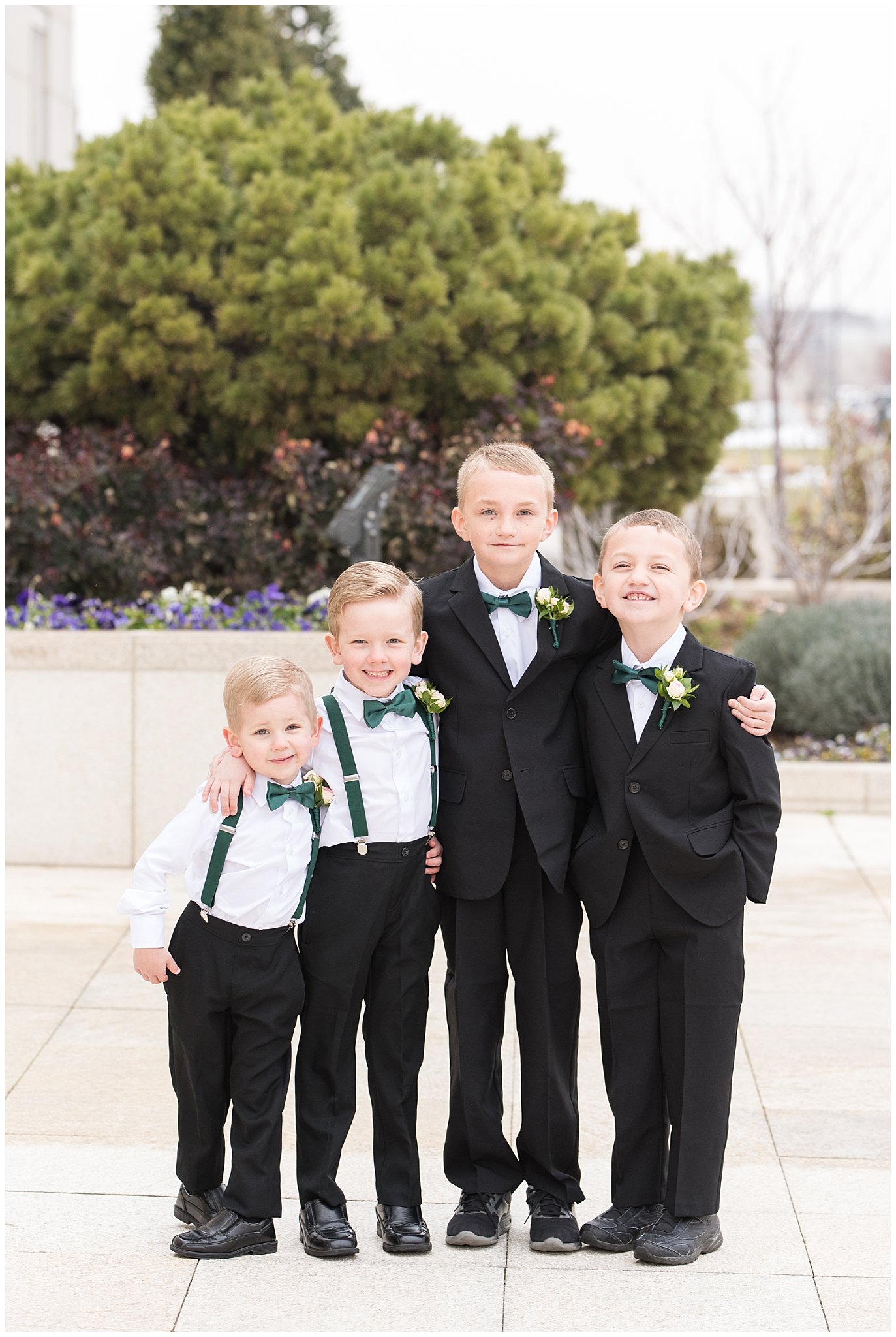 Four ring bearers in green bowties, suits and suspenders | Ogden Temple Winter Wedding | Emerald Green and Pink Wedding | Jessie and Dallin Photography