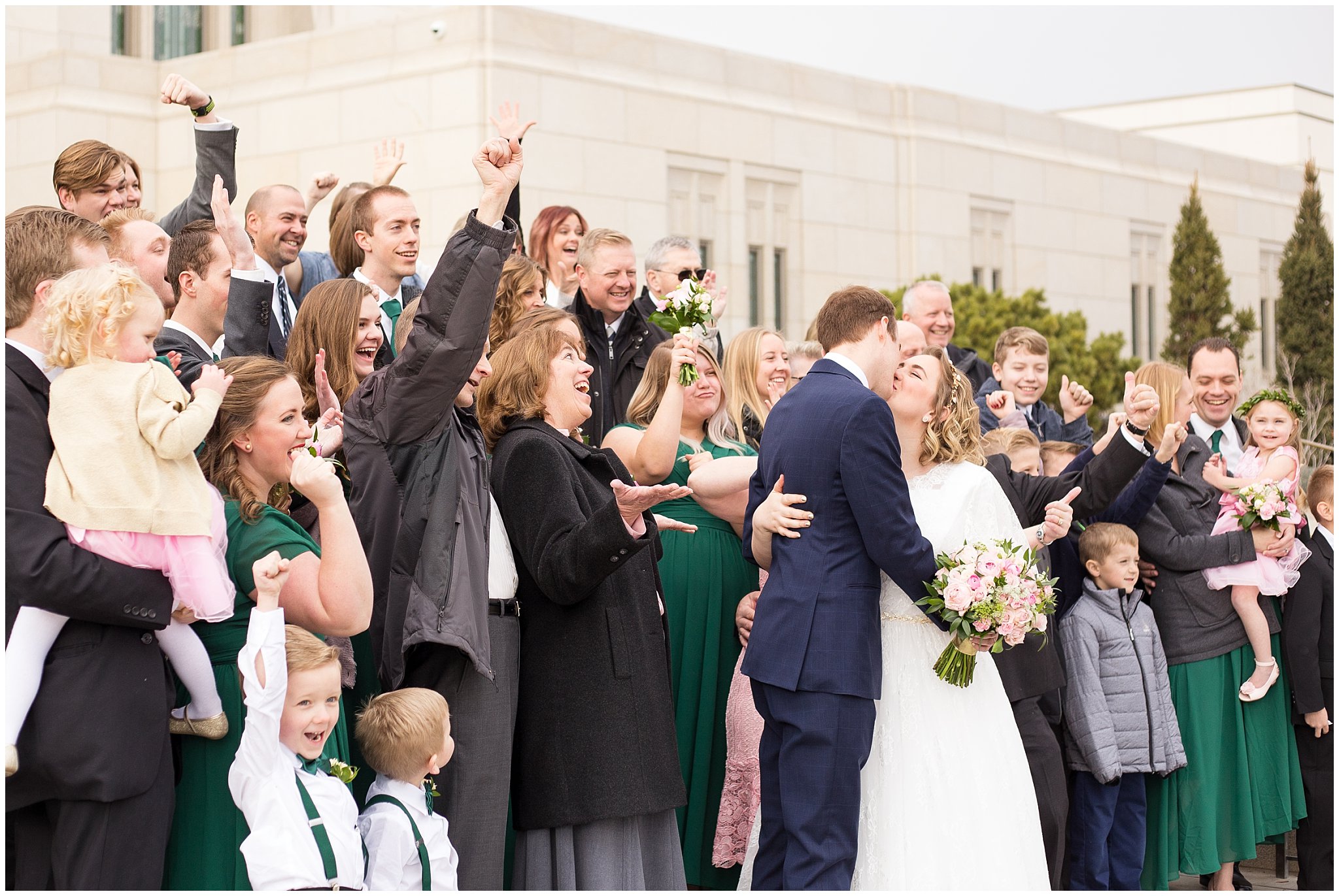 Group cheering at the temple | Ogden Temple Winter Wedding | Emerald Green and Pink Wedding | Jessie and Dallin Photography