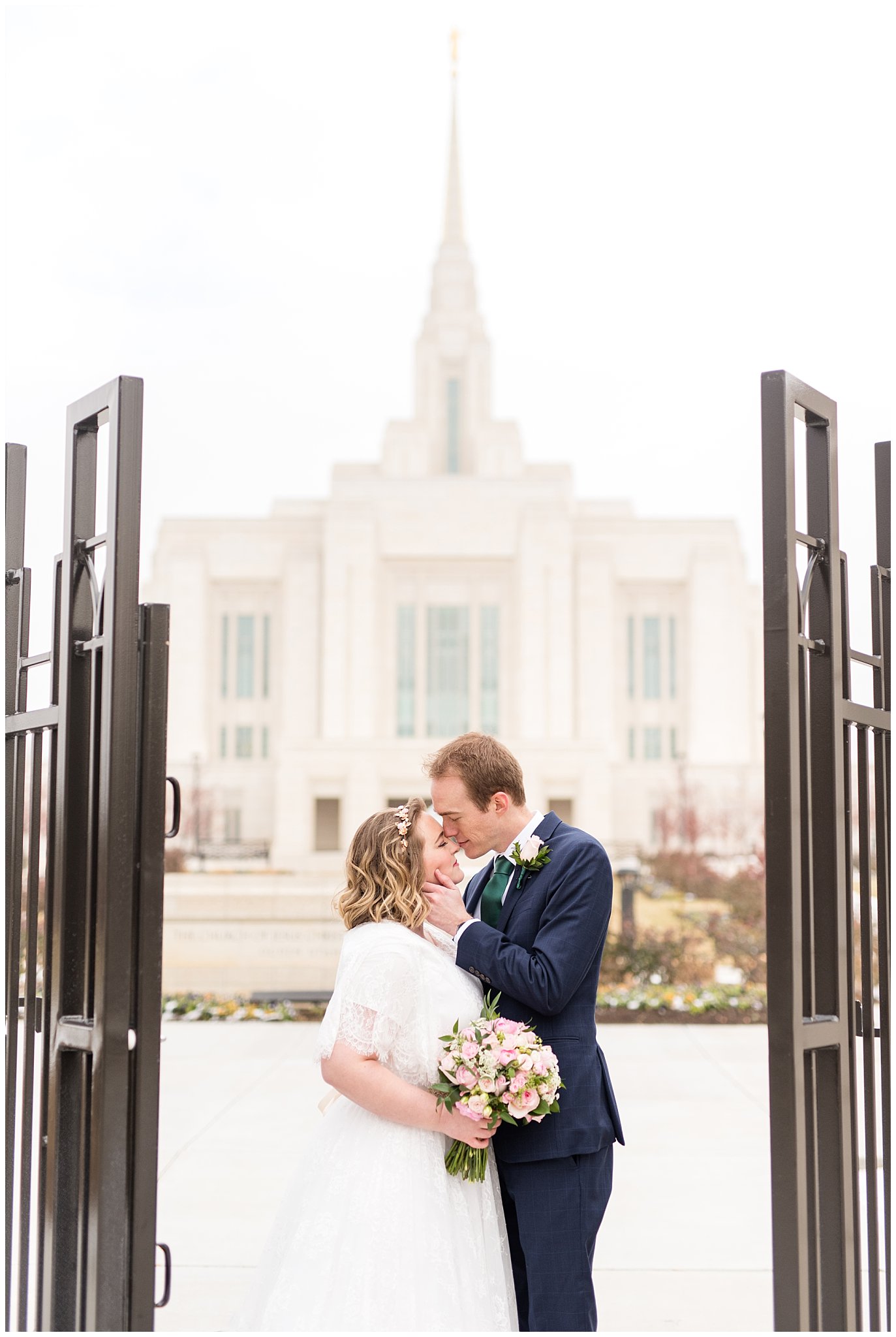 Bride and groom at Ogden temple gate | Ogden Temple Winter Wedding | Emerald Green and Pink Wedding | Jessie and Dallin Photography