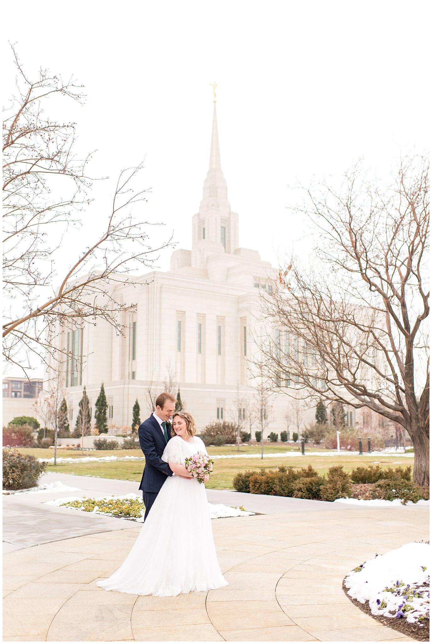 Bride and groom epic shot in front of Ogden temple | Ogden Temple Winter Wedding | Emerald Green and Pink Wedding | Jessie and Dallin Photography