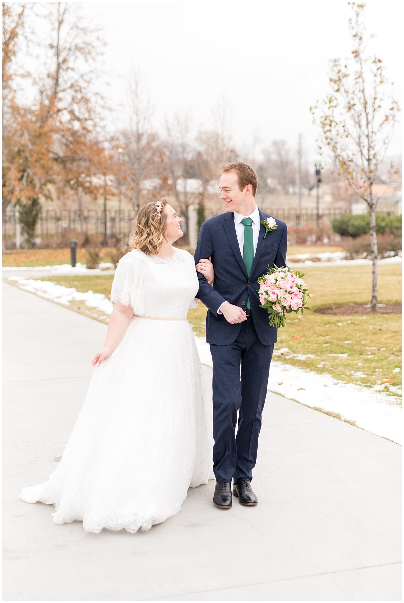 Bride and groom walking on temple grounds | Ogden Temple Winter Wedding | Emerald Green and Pink Wedding | Jessie and Dallin Photography