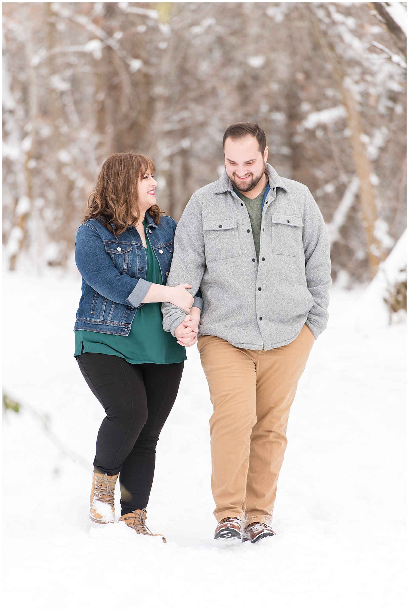 Couple walking and laughing in the winter forest | Winter Engagement at Mueller Park and the Utah State Capitol | Jessie and Dallin Photography
