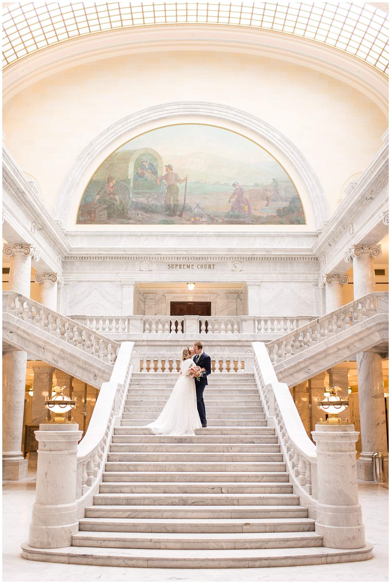 Bride and groom kiss on steps of grand staircase | Winter Formals at the Utah State Capitol | Utah Wedding Photography