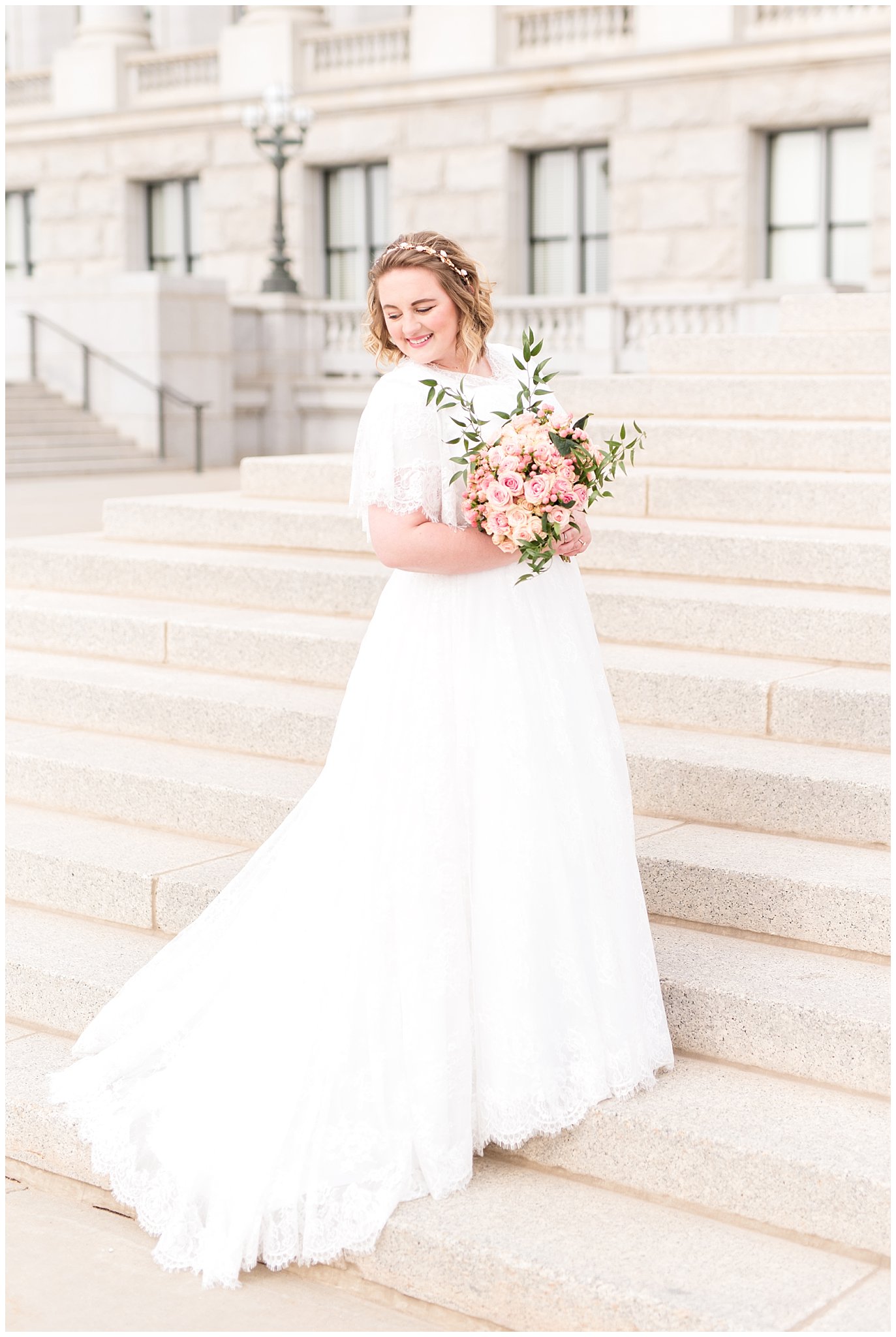 Bride laughing and holding bouquet of pink roses on steps | Winter Formals at the Utah State Capitol | Utah Wedding Photography