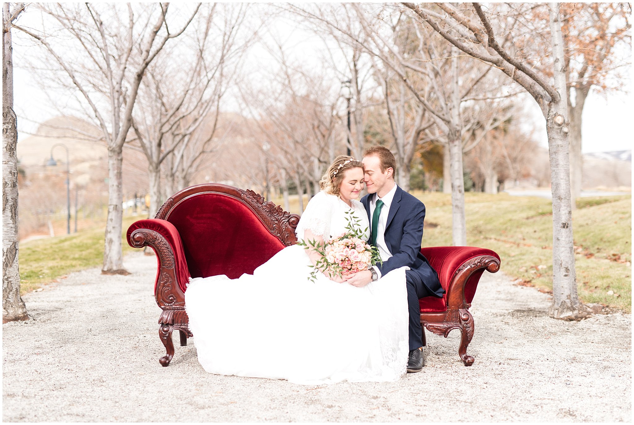 Bride and groom sit on red vintage couch | Winter Formals at the Utah State Capitol | Utah Wedding Photography