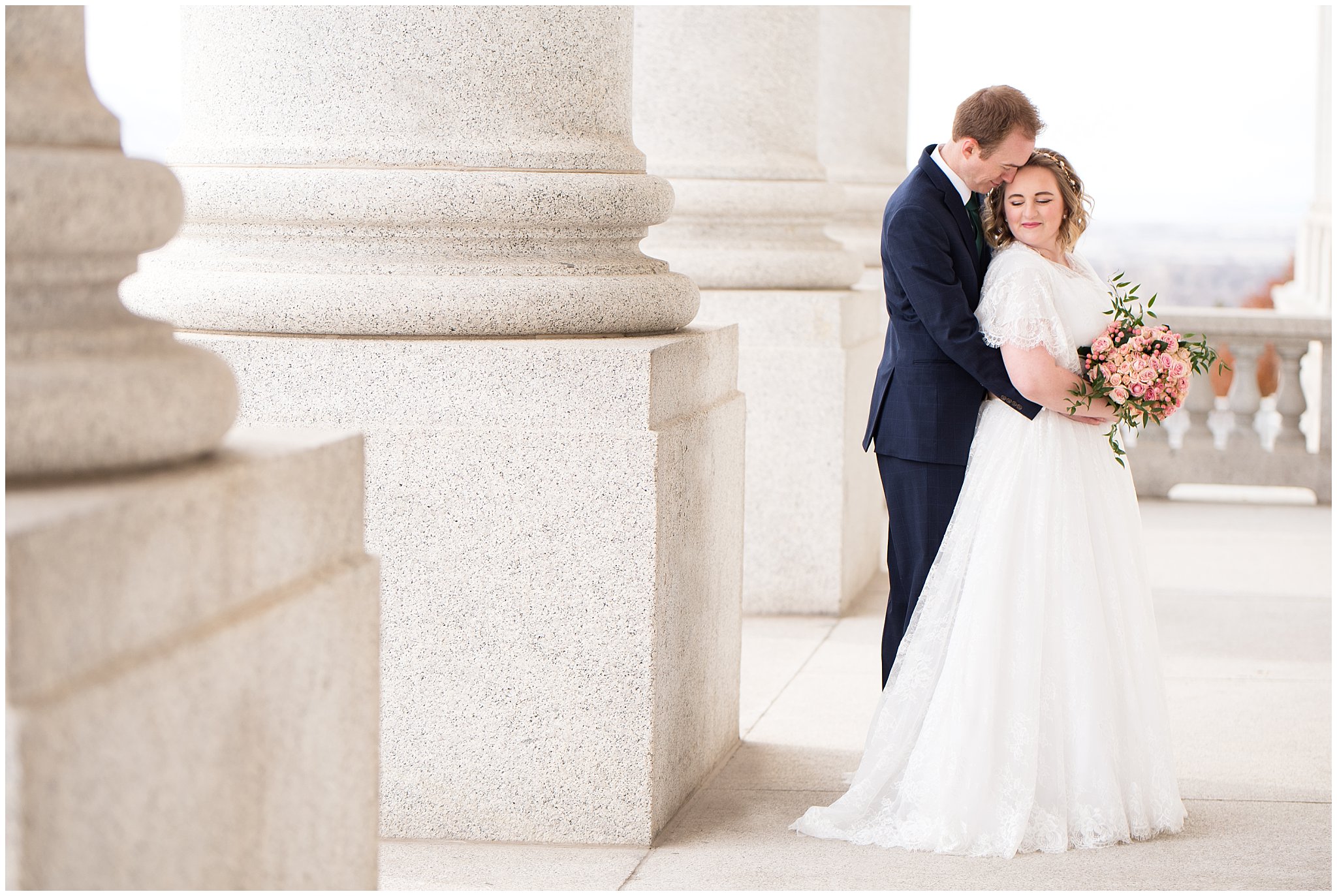Bride and groom stand next to capitol columns | Winter Formals at the Utah State Capitol | Utah Wedding Photography