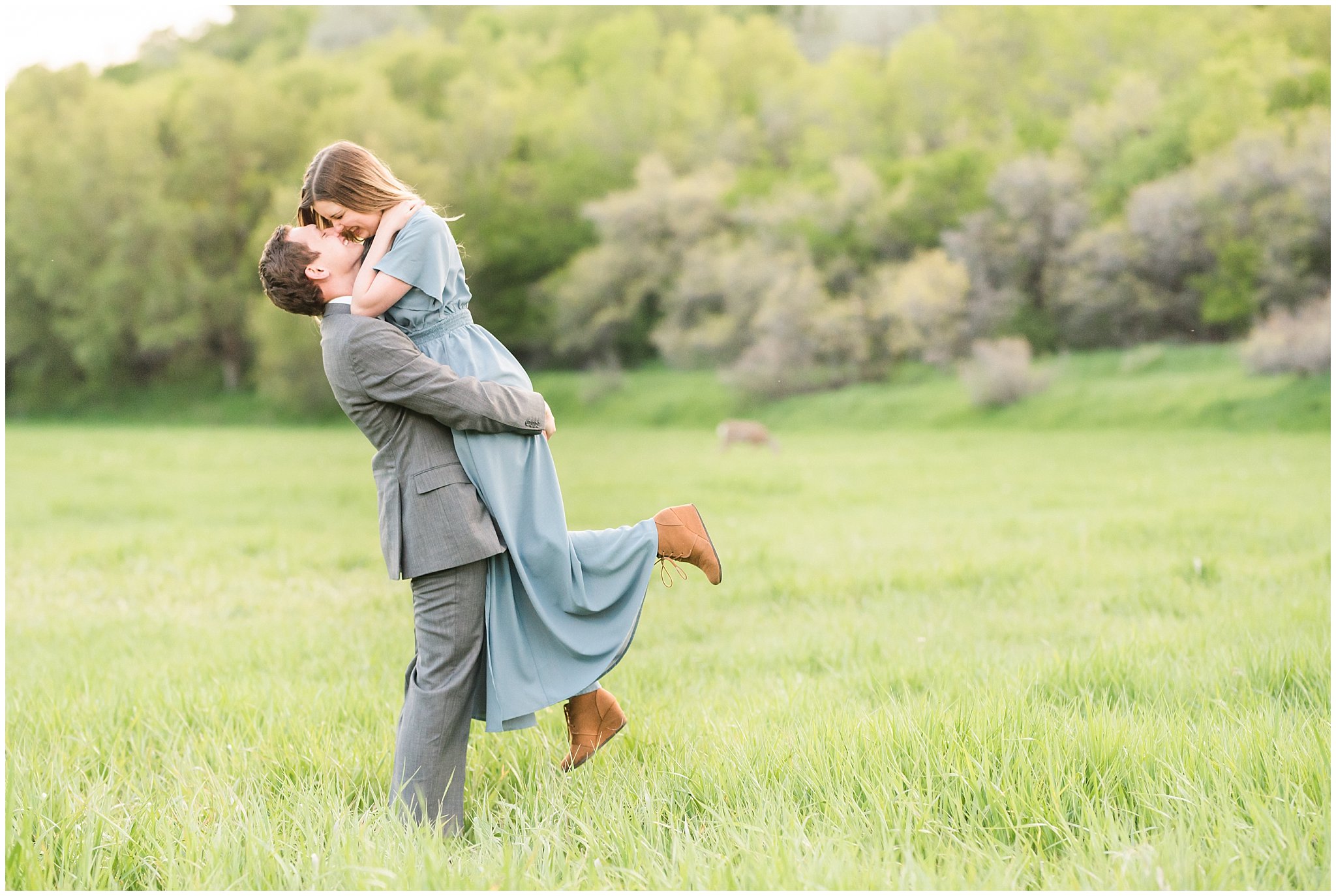 Couple dressed up in flowing dress and suit in a meadow for engagements | Jessie and Dallin Photography