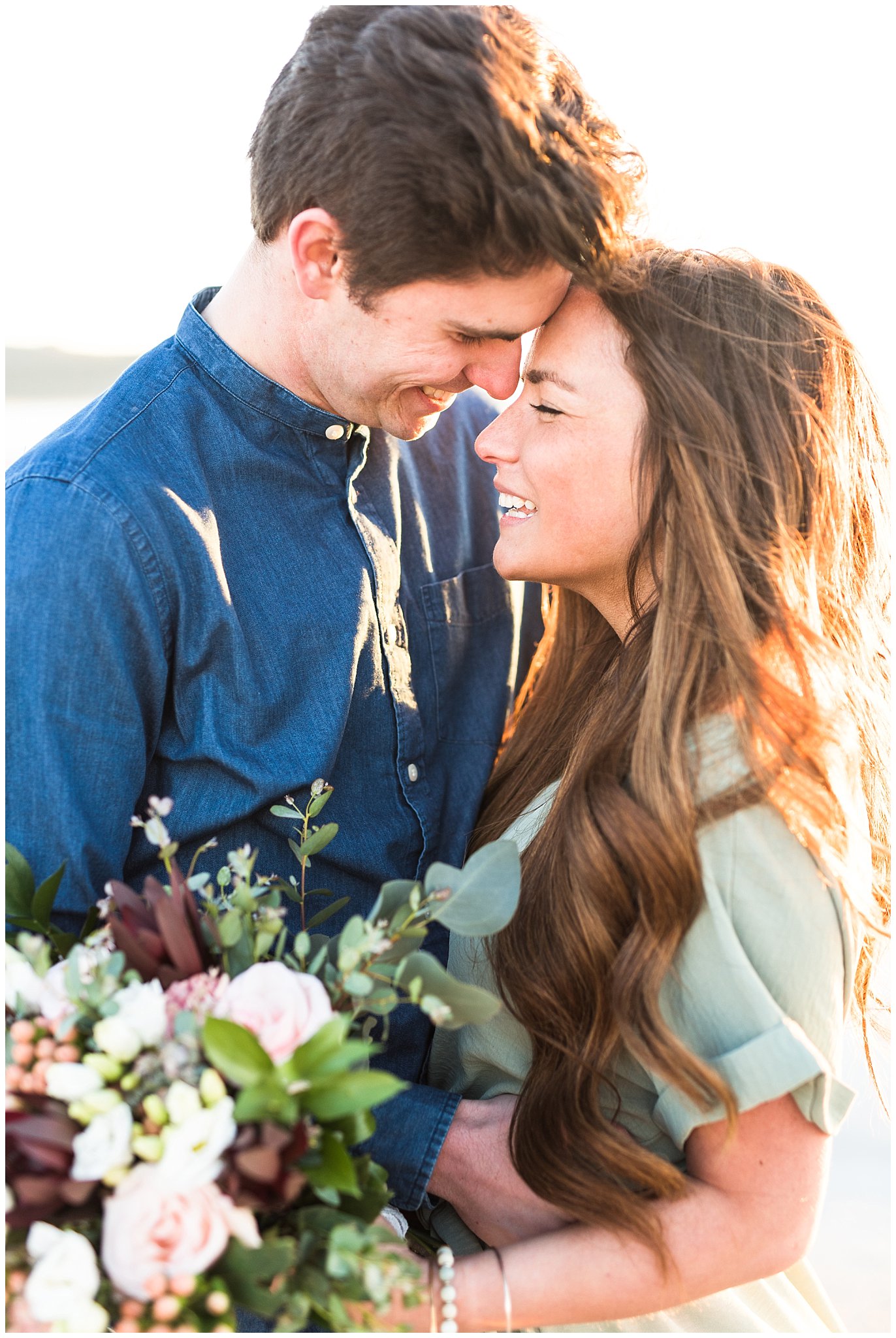 Couple with bouquet on the beach | Antelope Island Engagements | Utah Wedding Photographers | Jessie and Dallin Photography