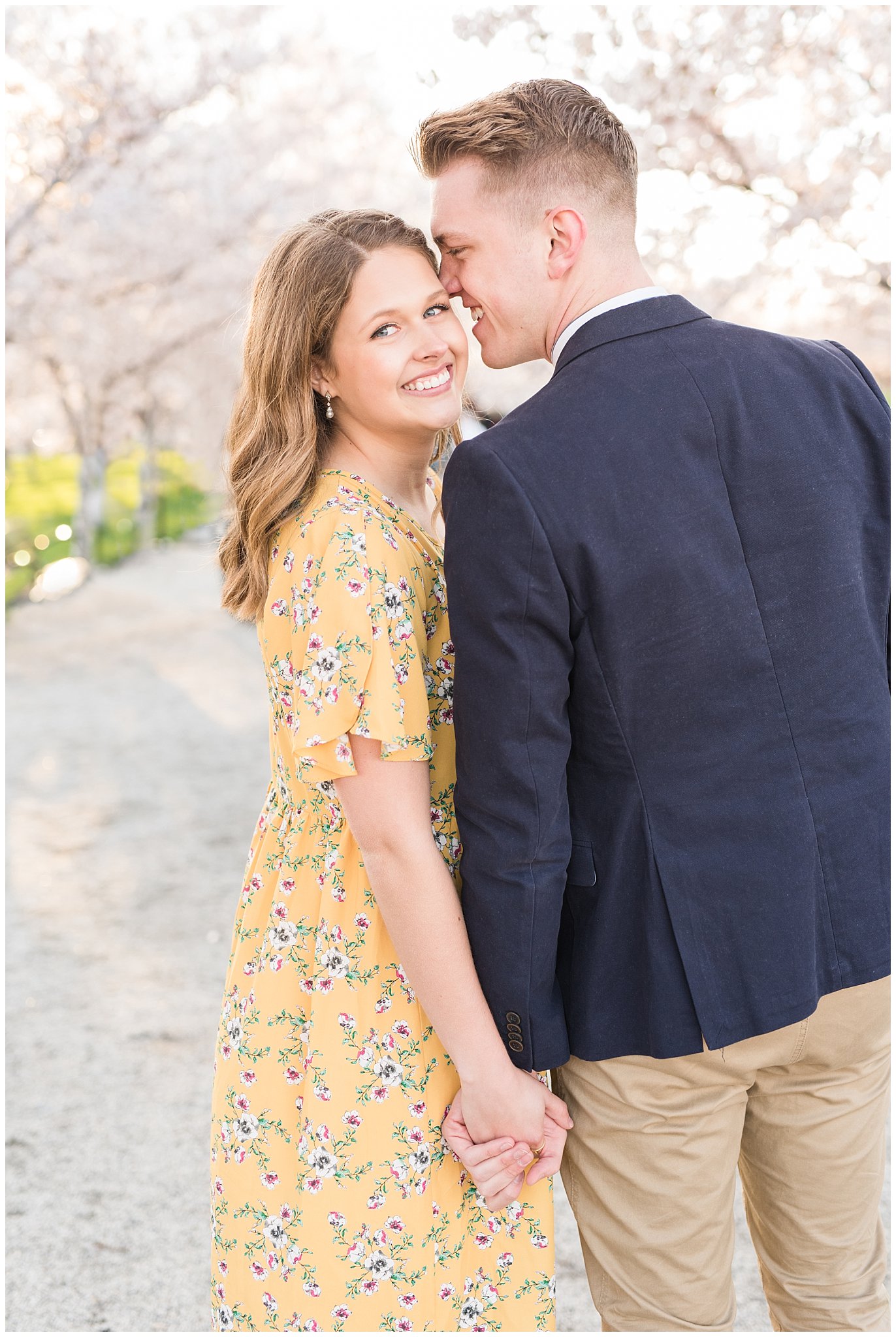 Couple dressed up in suit and yellow dress in the cherry blossoms | Spring Blossom Engagement at the Utah State Capitol | Utah Wedding Photographers | Jessie and Dallin