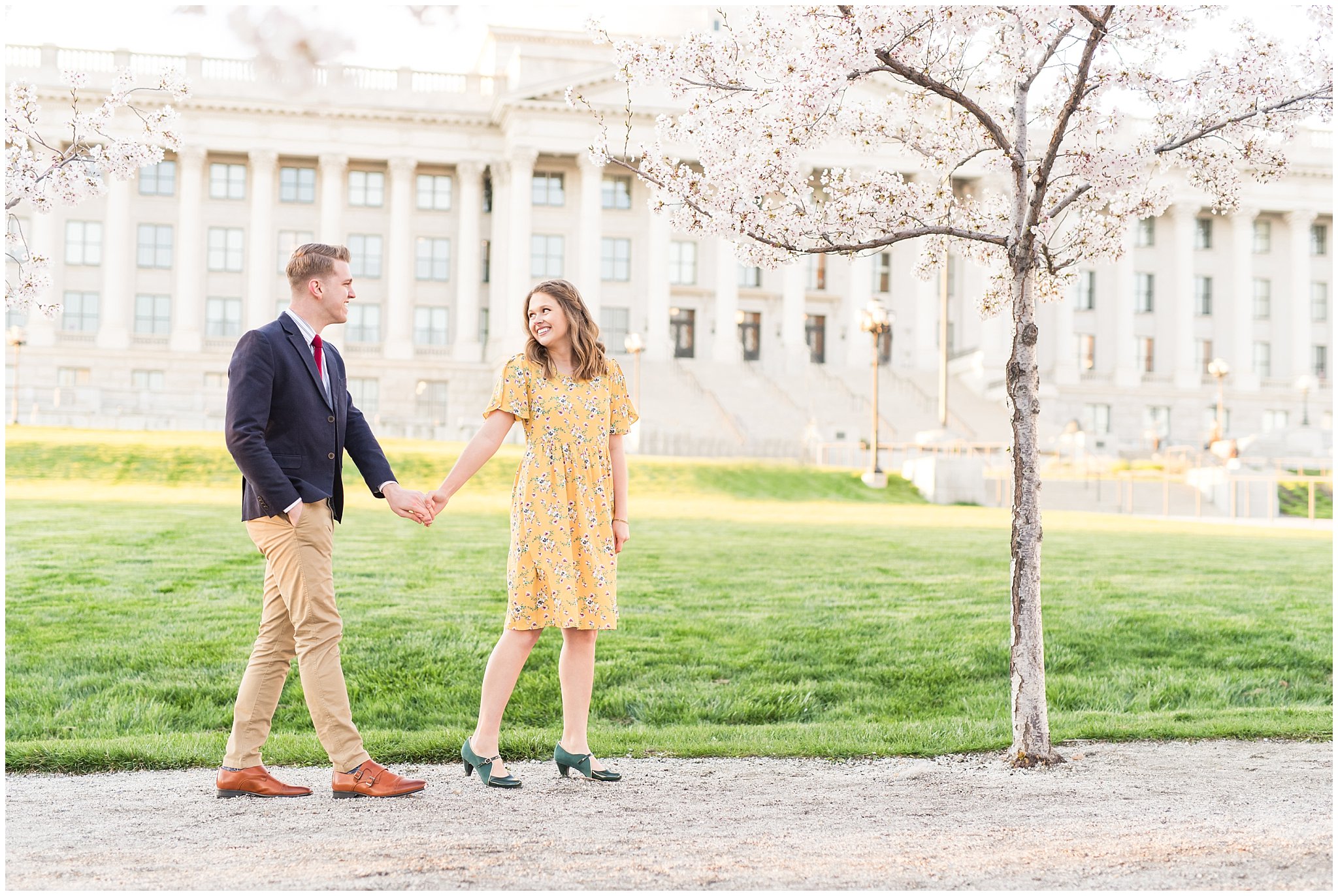 Couple dressed up in suit and yellow dress in the cherry blossoms | Spring Blossom Engagement at the Utah State Capitol | Utah Wedding Photographers | Jessie and Dallin