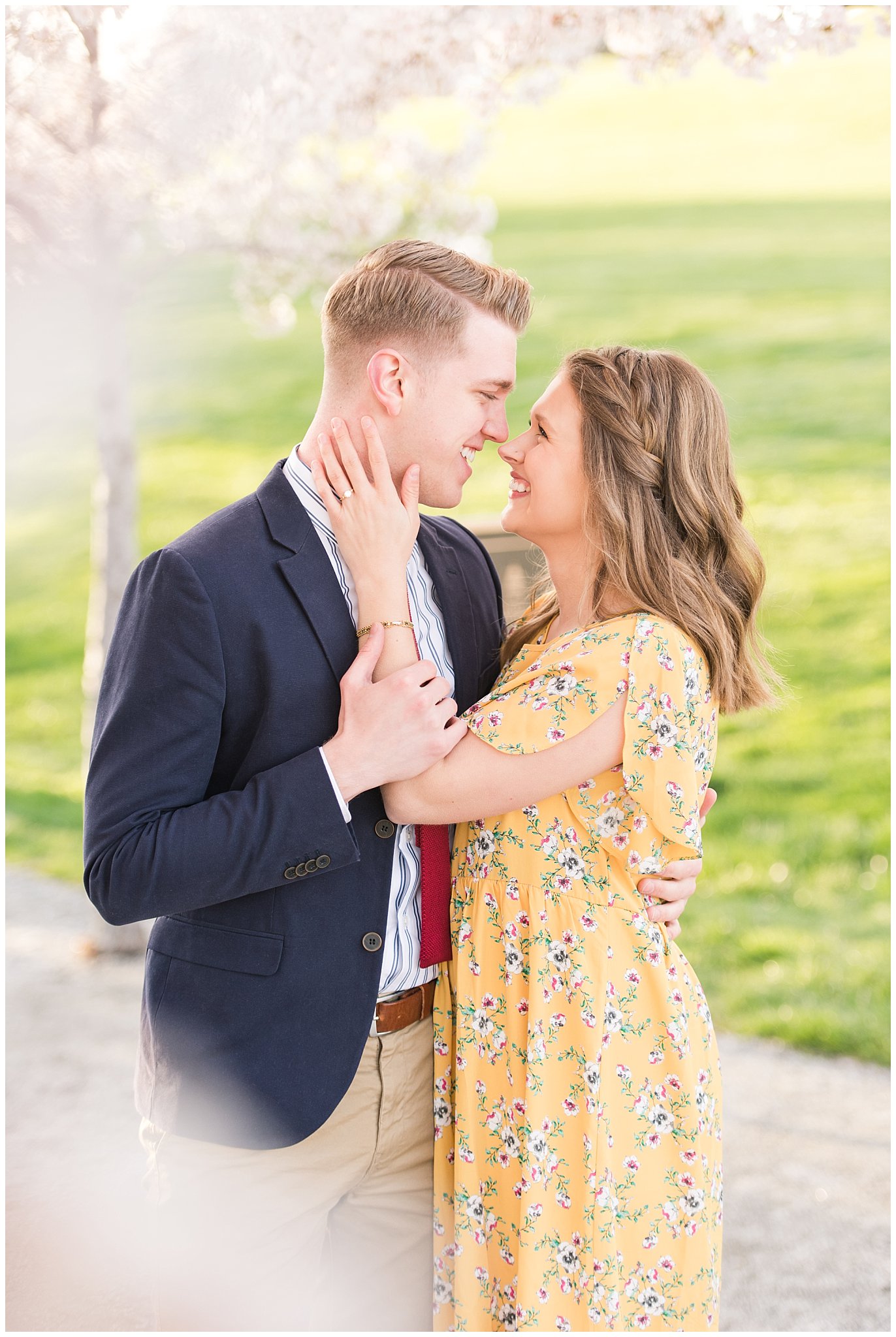 Couple dressed up in suit and yellow dress in the cherry blossoms | Spring Blossom Engagement at the Utah State Capitol | Utah Wedding Photographers | Jessie and Dallin